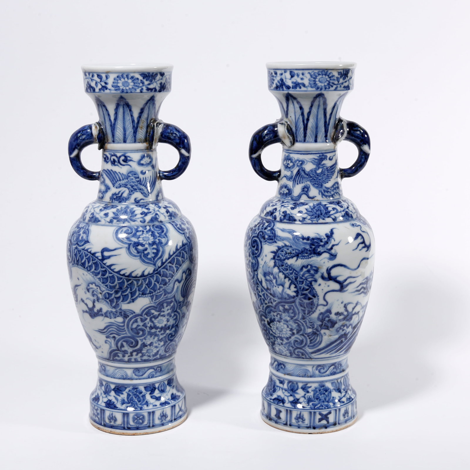 A PAIR OF BLUE AND WHITE DOUBLE-EARED VASES WITH DRAGON AMIDST FLORAL PATTERN: Pair of Blue and White Double-eared Vases with Dragon Amidst Floral Pattern