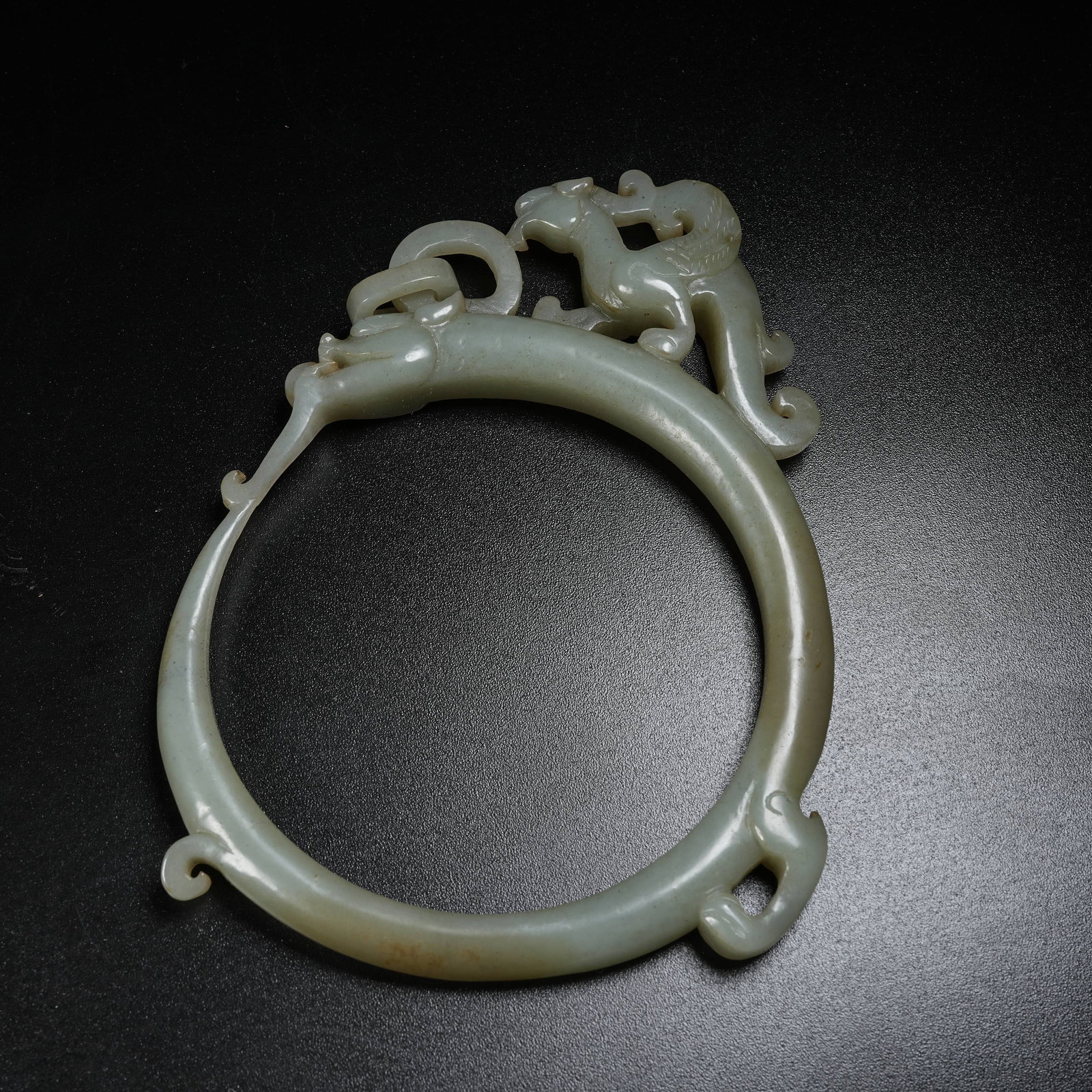 A HOTAN JADE RING WITH DRAGON AND PHOENIX PATTERN: Hotan Jade Ring with Dragon and Phoenix Pattern