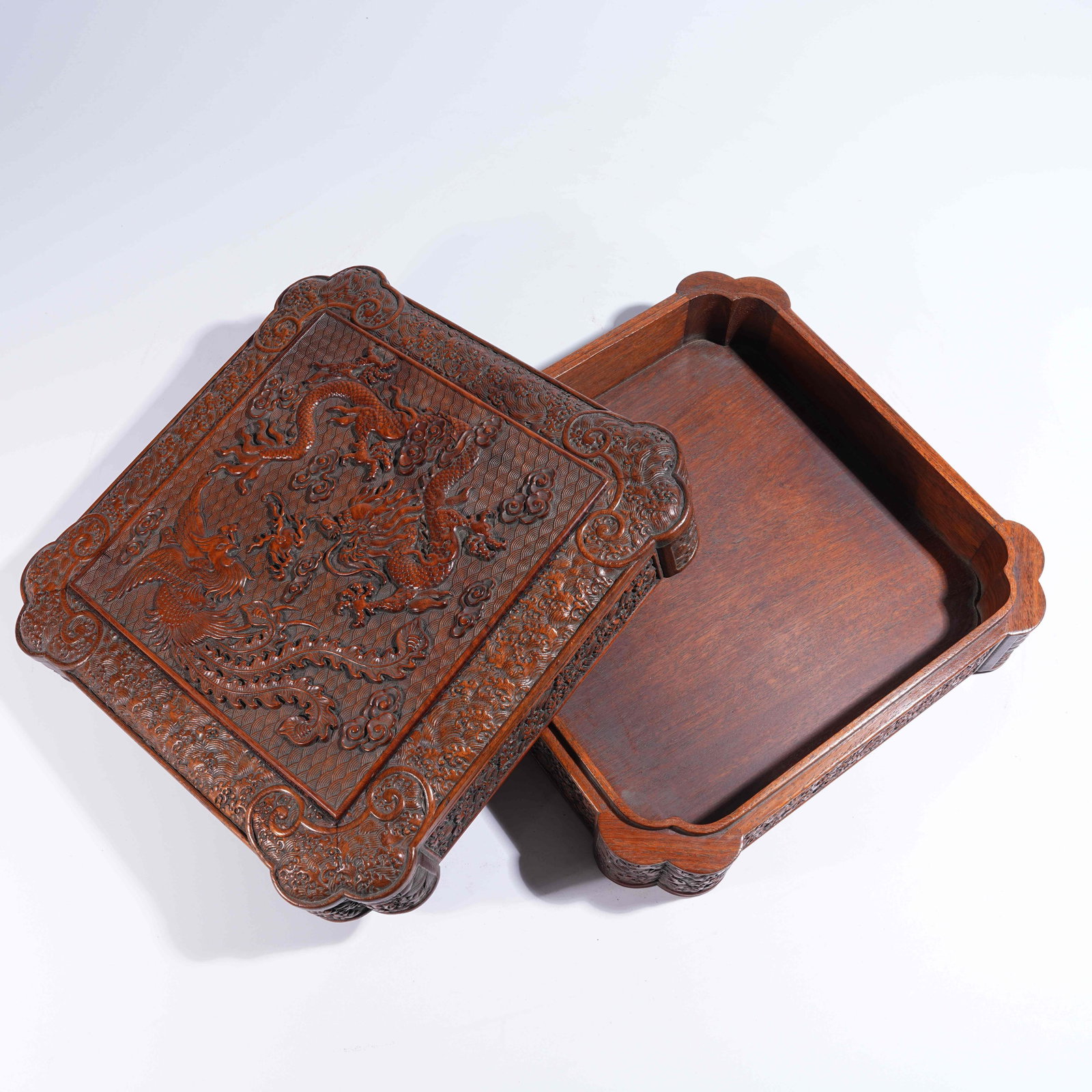 A HUANGHUALI SQUARE COVERED BOX WITH CANTED CORNERS AND DRAGON-AND-PHOENIX MOTIFS: Huanghuali Square Covered Box with Canted Corners and Dragon-and-Phoenix Motifs
