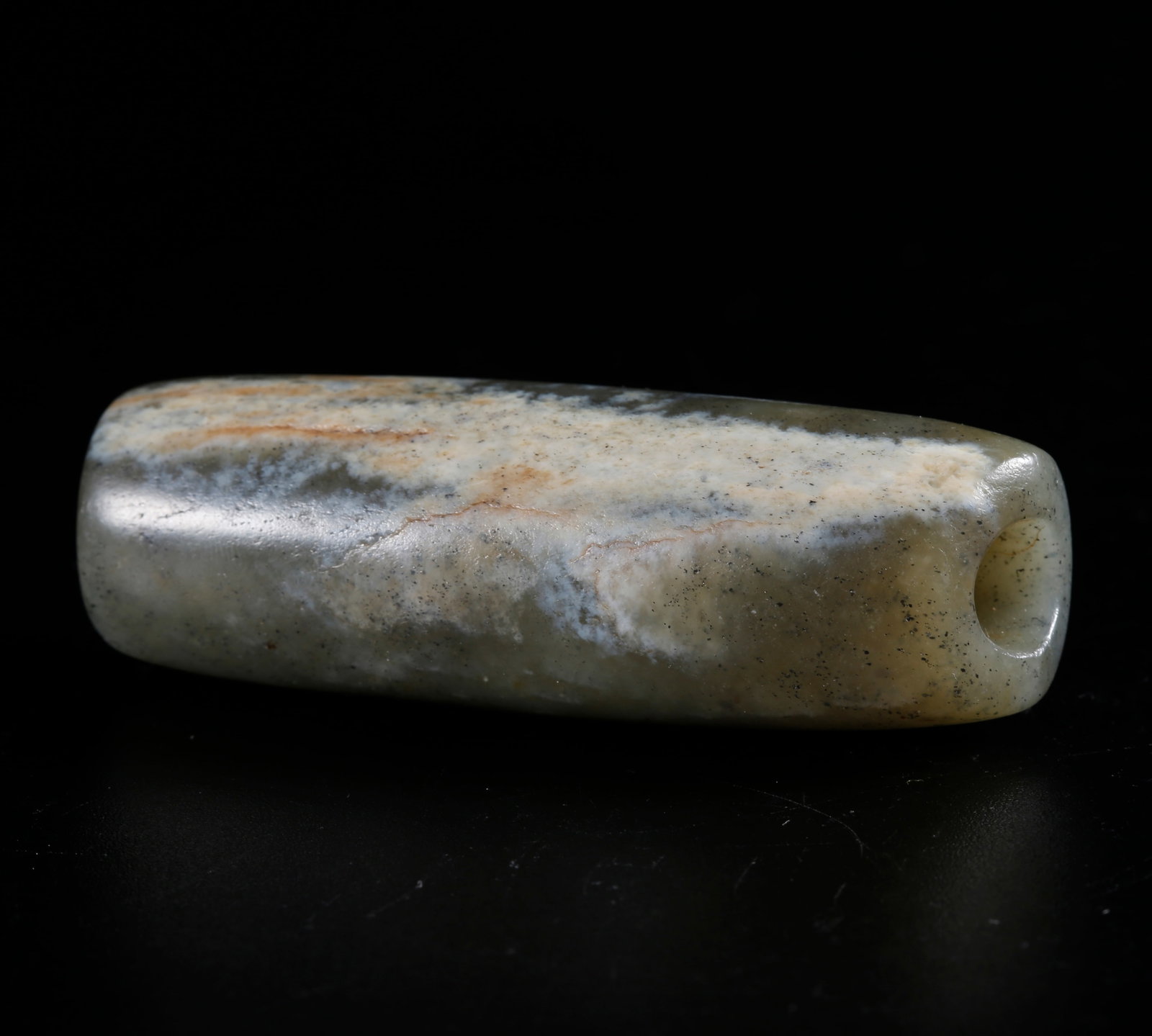 A HETIAN JADE CARVED CYLINDRICAL BEAD: Hetian Jade Carved Cylindrical Bead
