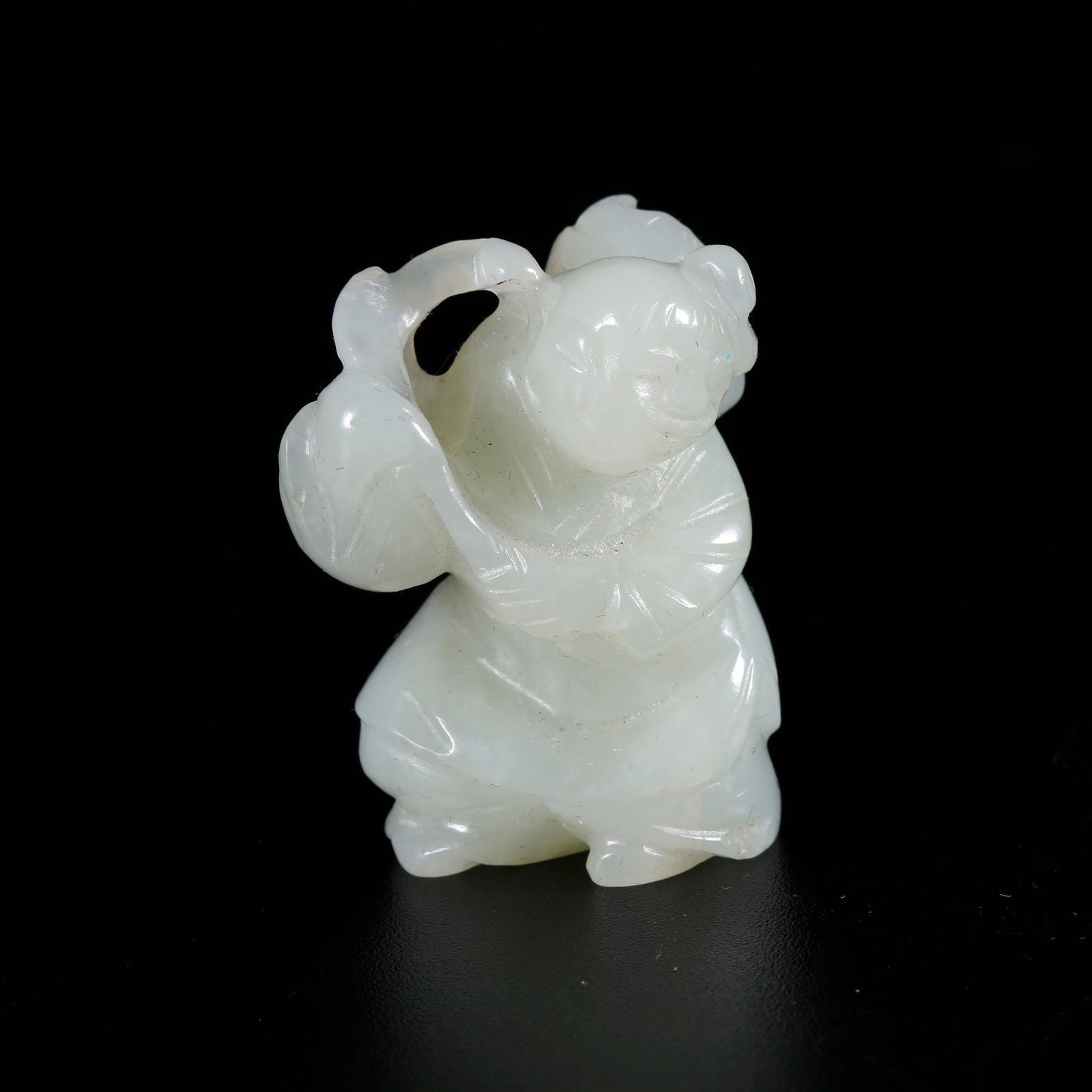 A HETIAN JADE CARVED BOY-SHAPED ORNAMENT: Hetian Jade Carved Boy-shaped Ornament
