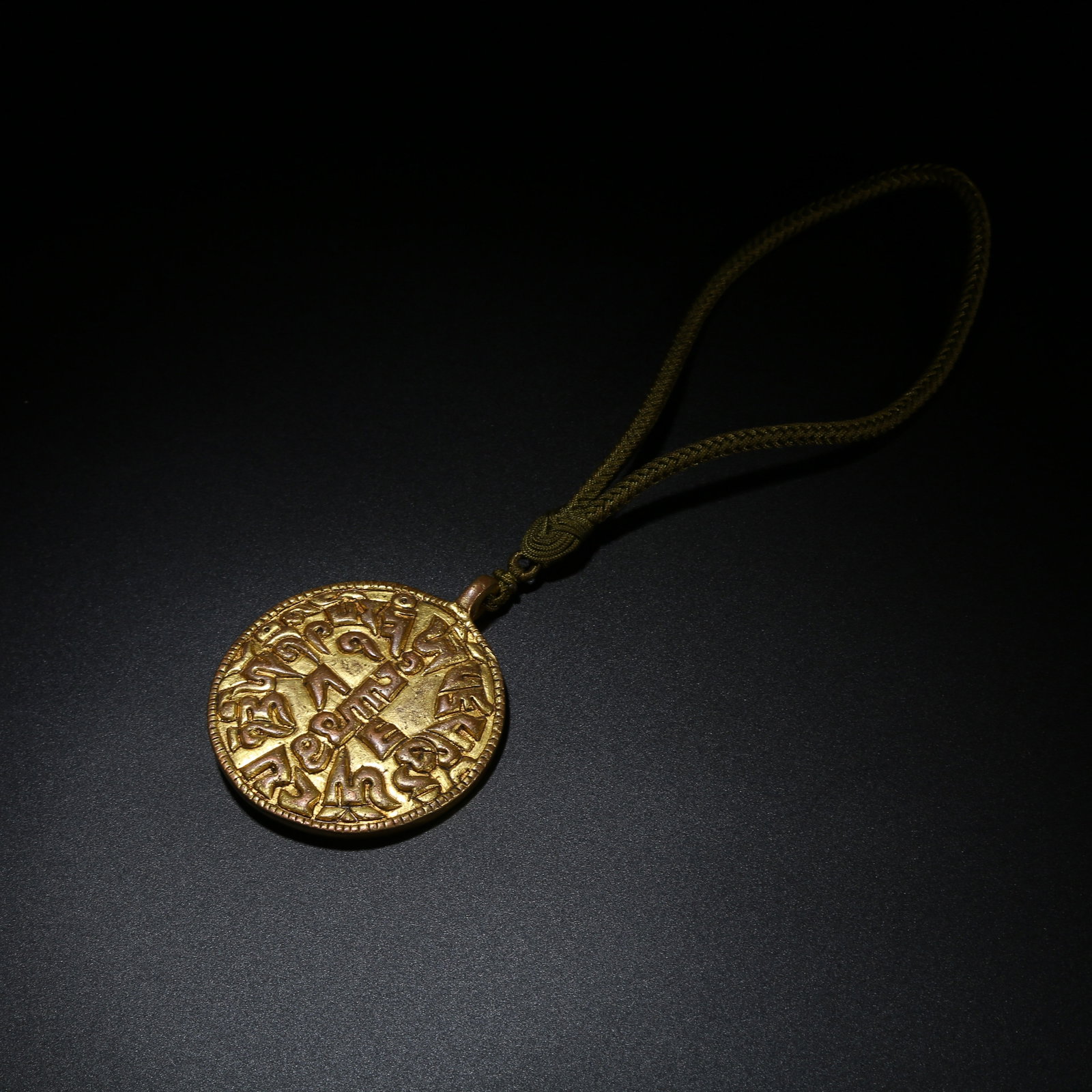 A GILT BRONZE MANTRA PLAQUE INLAID WITH TURQUOISE: Gilt Bronze Mantra Plaque Inlaid with Turquoise