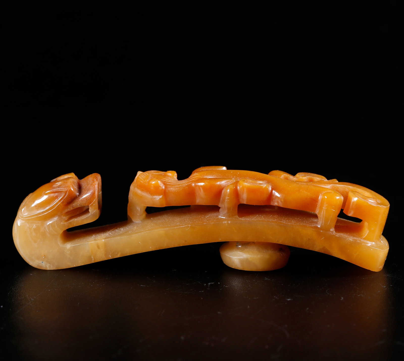 A HETIAN JADE CARVED DRAGON-SHAPED BELT HOOK: Hetian Jade Carved Dragon-shaped Belt Hook