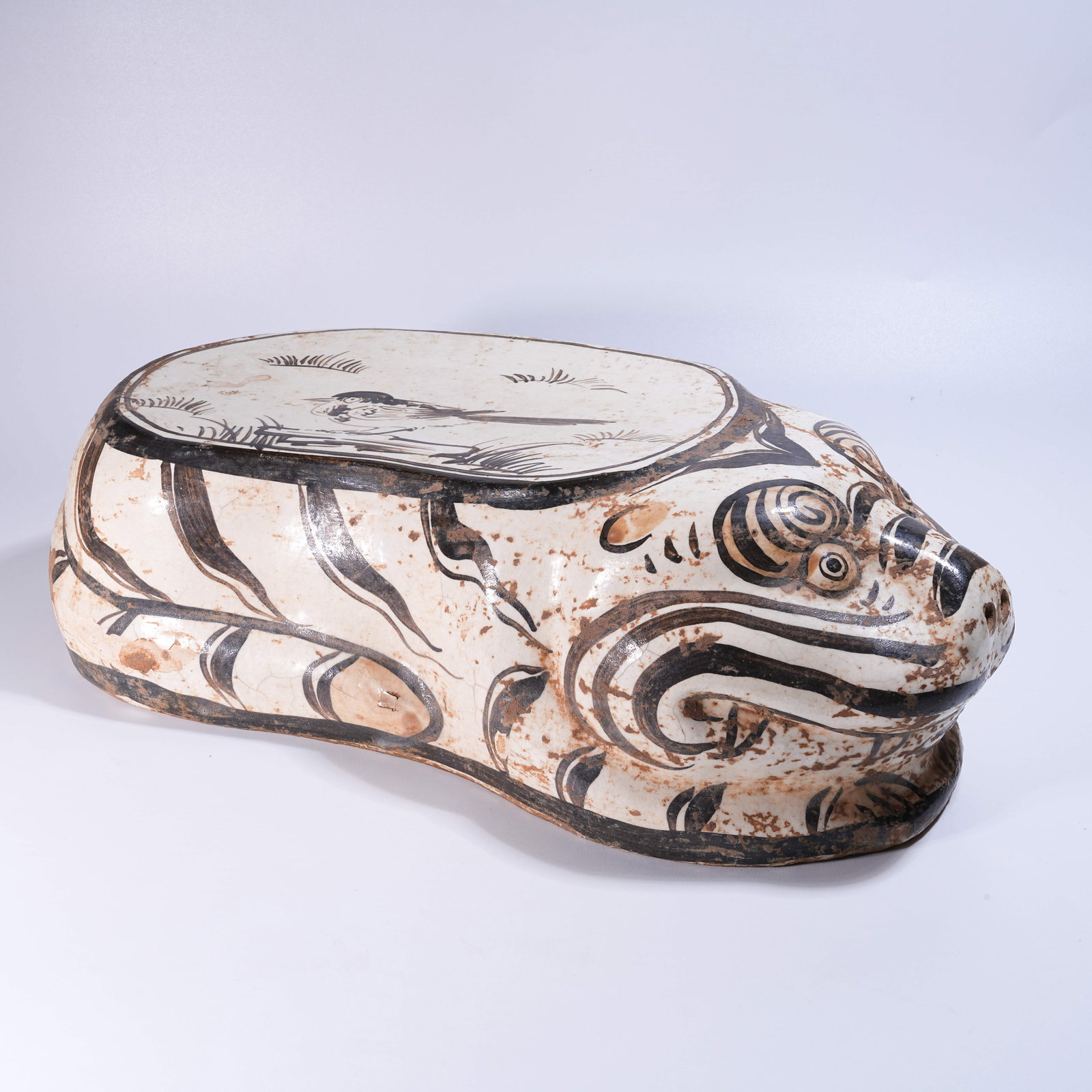 A CIZHOU KILN WHITE-GROUND BLACK-PAINTED TIGER PILLOW: Cizhou Kiln White-Ground Black-Painted Tiger Pillow