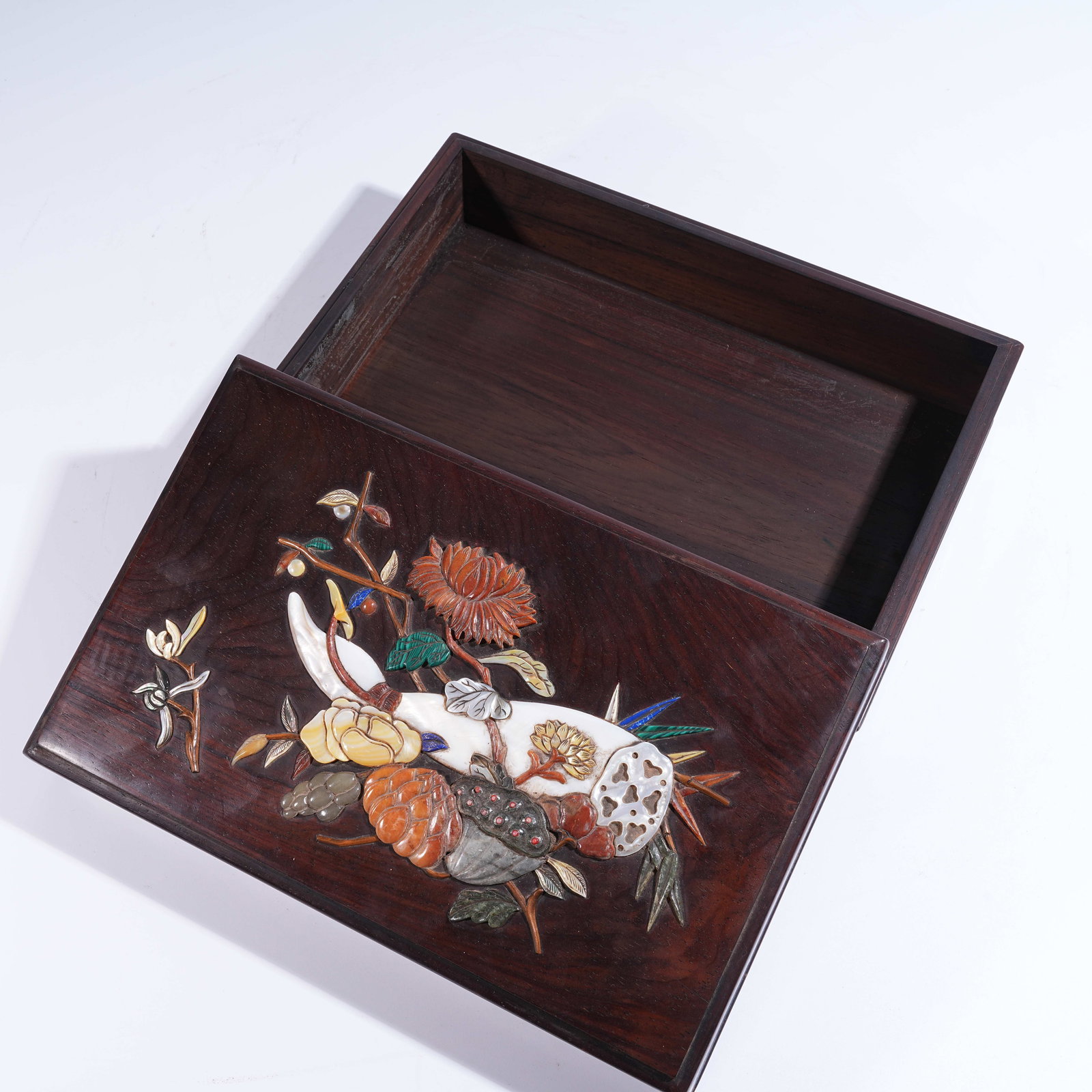 A HUANGHUALI COVERED BOX INLAID WITH "HUNDRED TREASURES" DEPICTING FLORAL AND AUSPICIOUS FRUIT: Huanghuali Covered Box Inlaid with "Hundred Treasures" Depicting Floral and Auspicious Fruit Motifs
