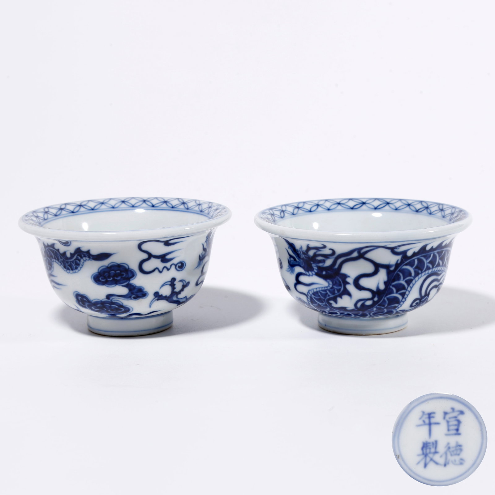 A PAIR OF BLUE AND WHITE CUPS WITH CLOUD AND DRAGON PATTERN: Pair of Blue and White Cups with Cloud and Dragon Pattern