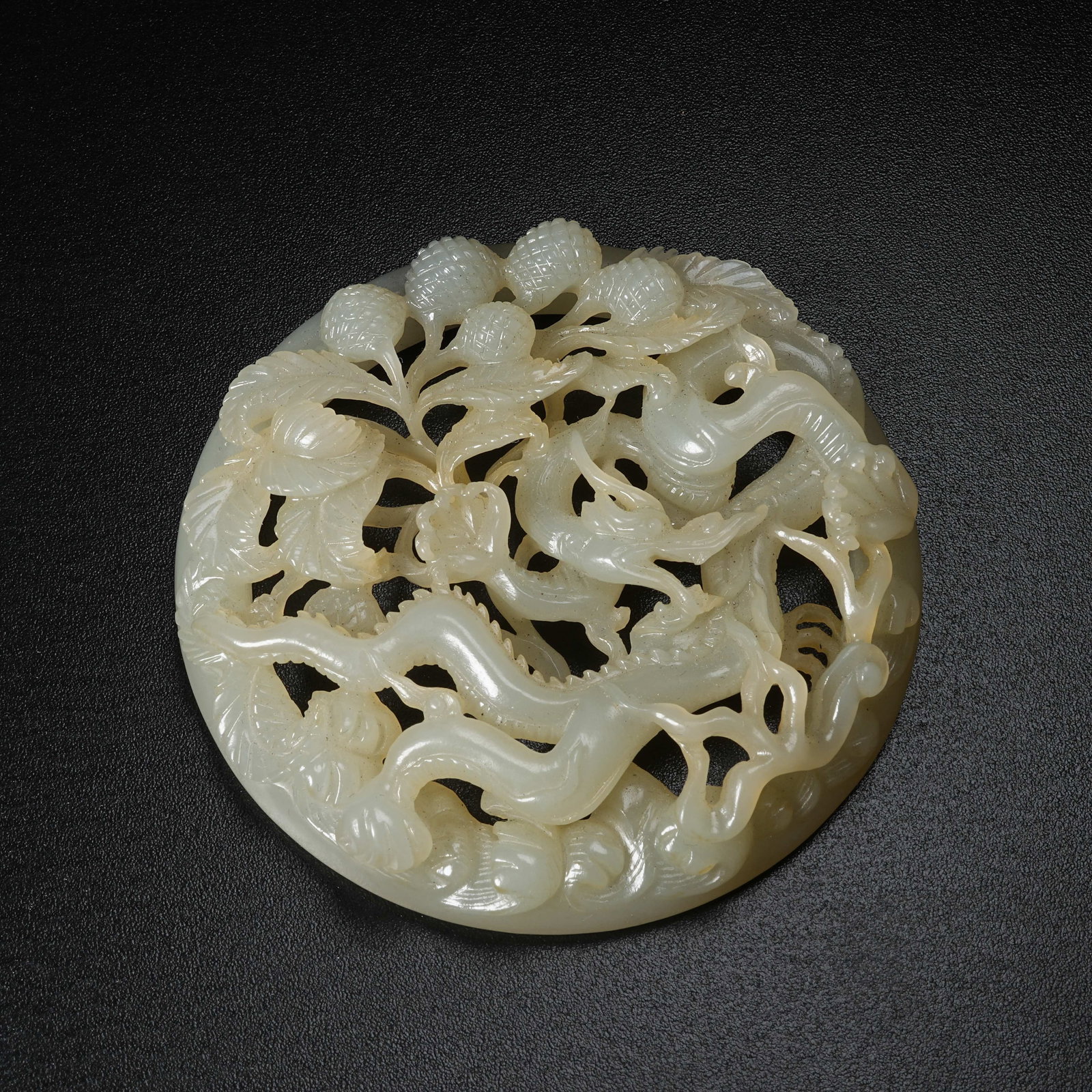 A HETIAN JADE BELT ORNAMENT WITH DRAGON PIERCING FLORAL PATTERN (1 of 9)