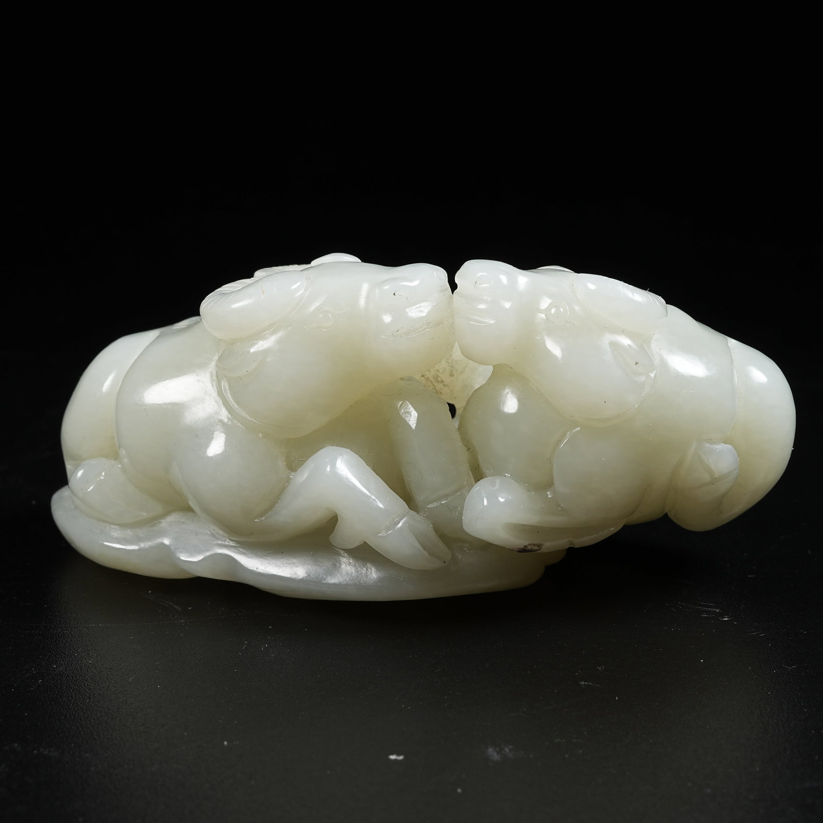 A HOTAN JADE ORNAMENT OF RECUMBENT OX: Hotan Jade Ornament of Recumbent Ox