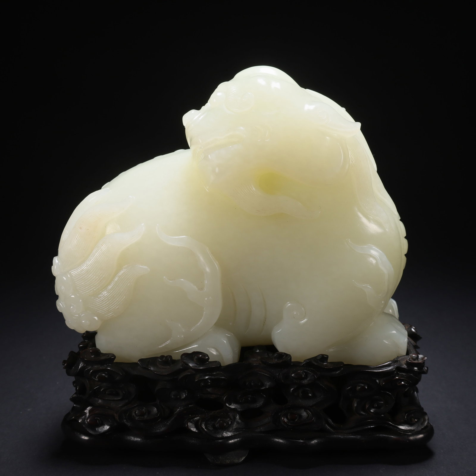 A HETIAN JADE WOODEN-BASE RIGHT-TURNING AUSPICIOUS BEAST (1 of 9)
