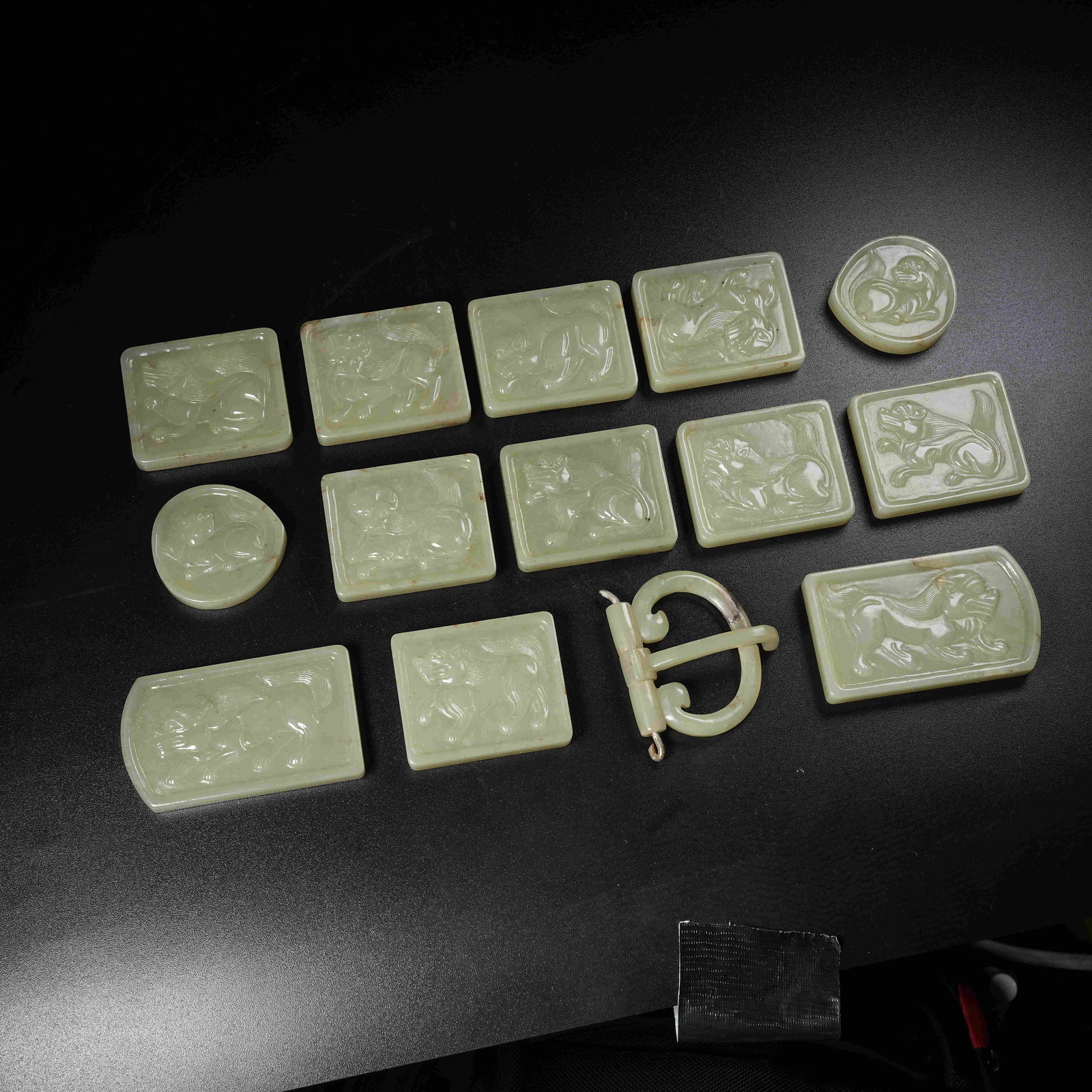 A GROUP OF HETIAN JADE BELT ORNAMENTS WITH HIGH-RELIEF LION PATTERN (1 of 9)
