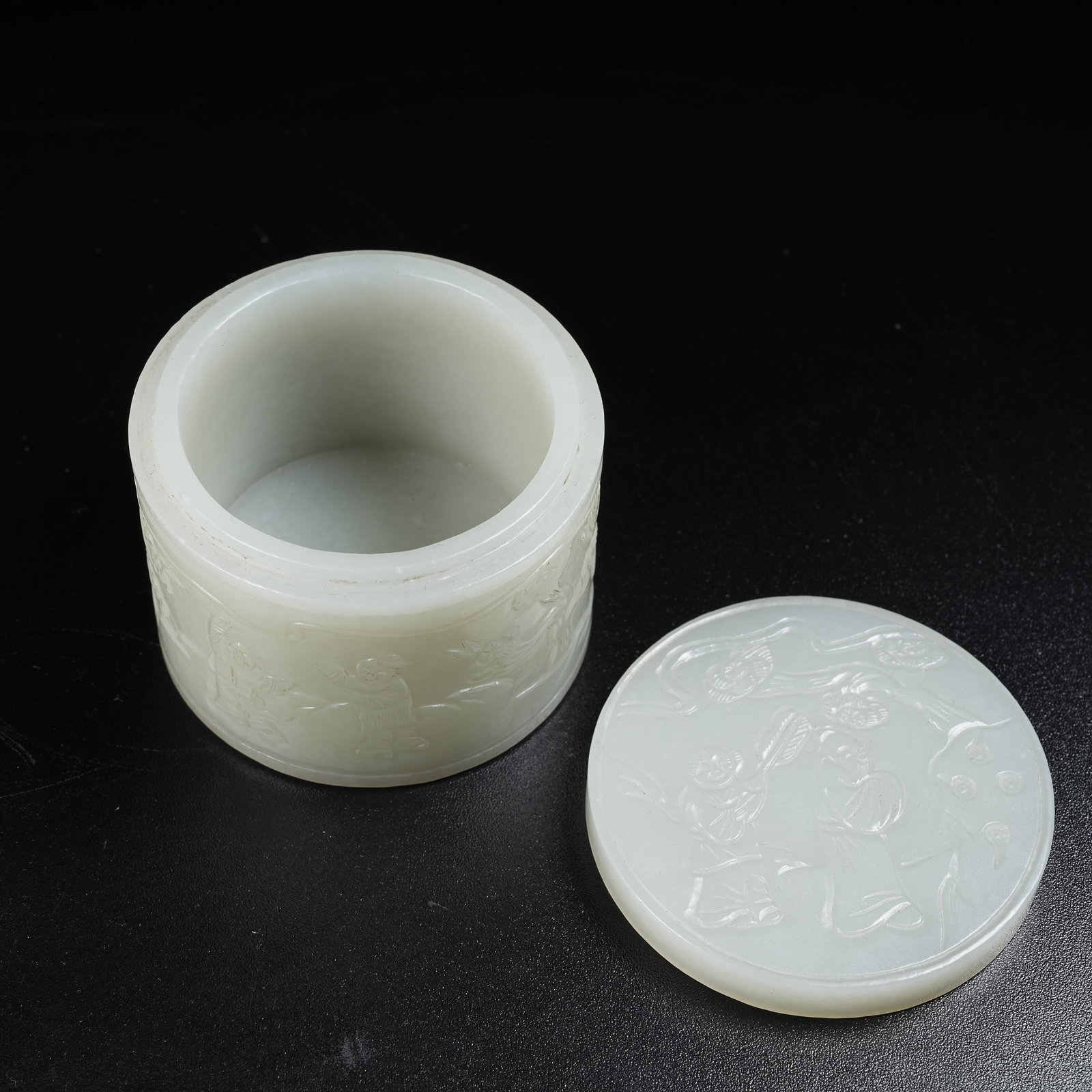 A HOTAN JADE THUMB RING BOX WITH CHILDREN AT PLAY PATTERN: Hotan Jade Thumb Ring Box with Children at Play Pattern
