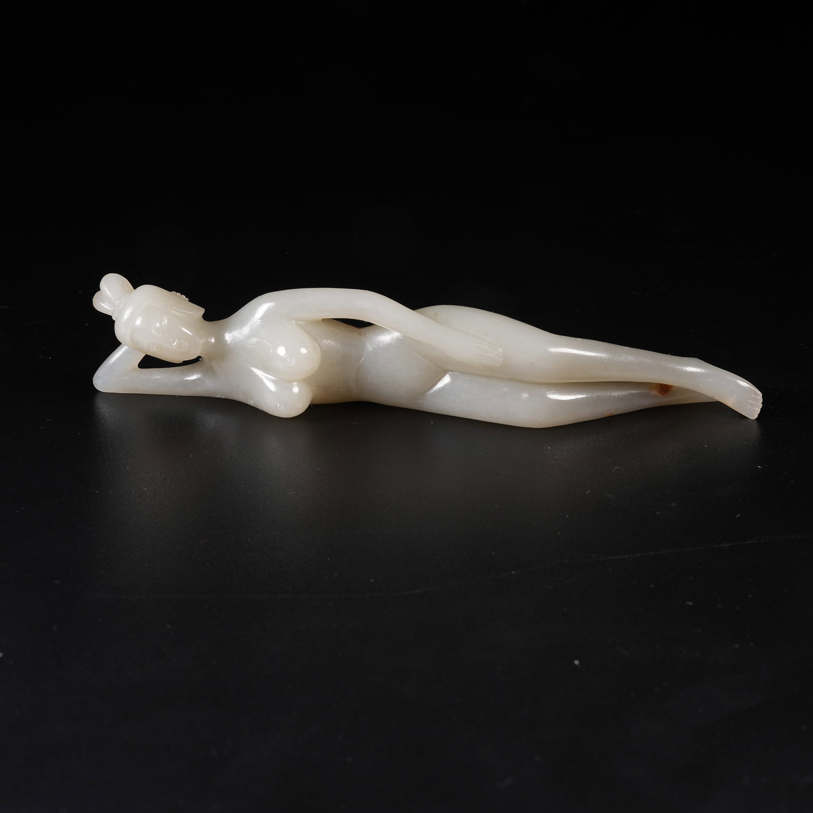 A HETIAN JADE RECUMBENT HUMAN FIGURE ORNAMENT: Hetian Jade Recumbent Human Figure Ornament