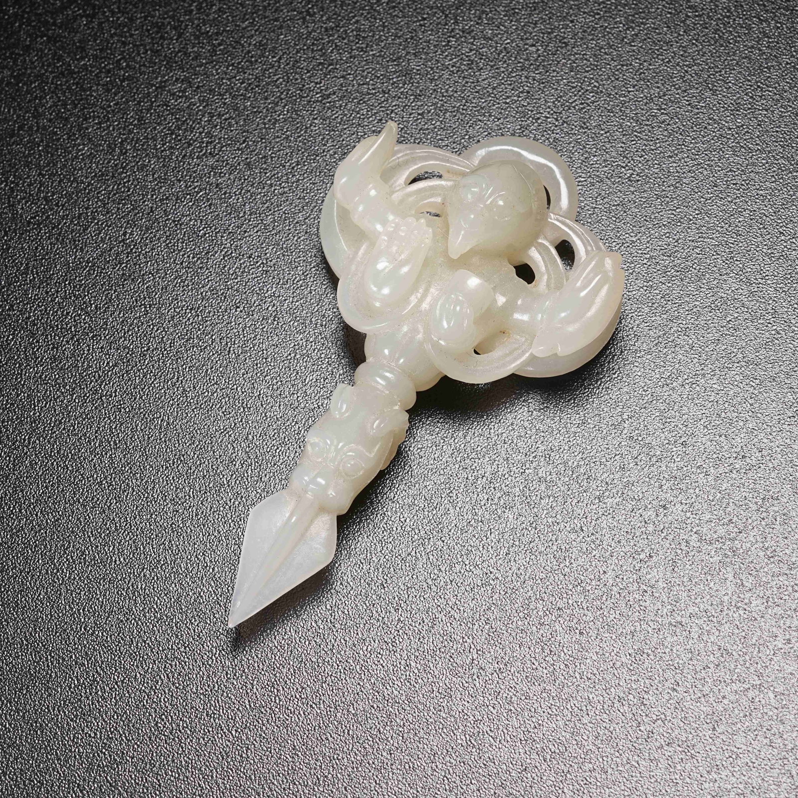 A HETIAN WHITE JADE VAJRA PESTLE WITH GARUDA MOTIF: Hetian White Jade Vajra Pestle with Garuda Motif