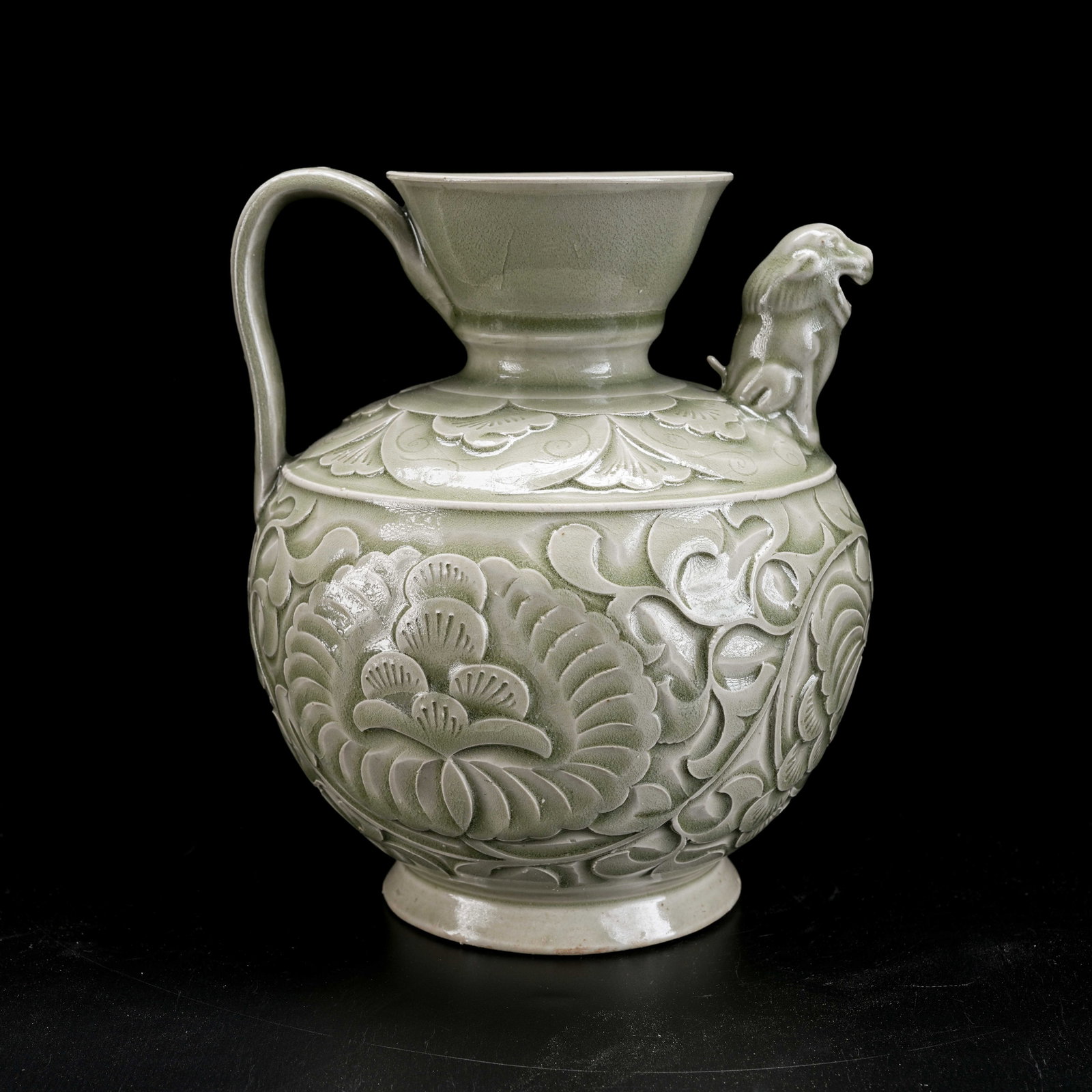 A YAOZHOU KILN CARVED BEAST-HEAD EWER: Yaozhou Kiln Carved Beast-Head Ewer