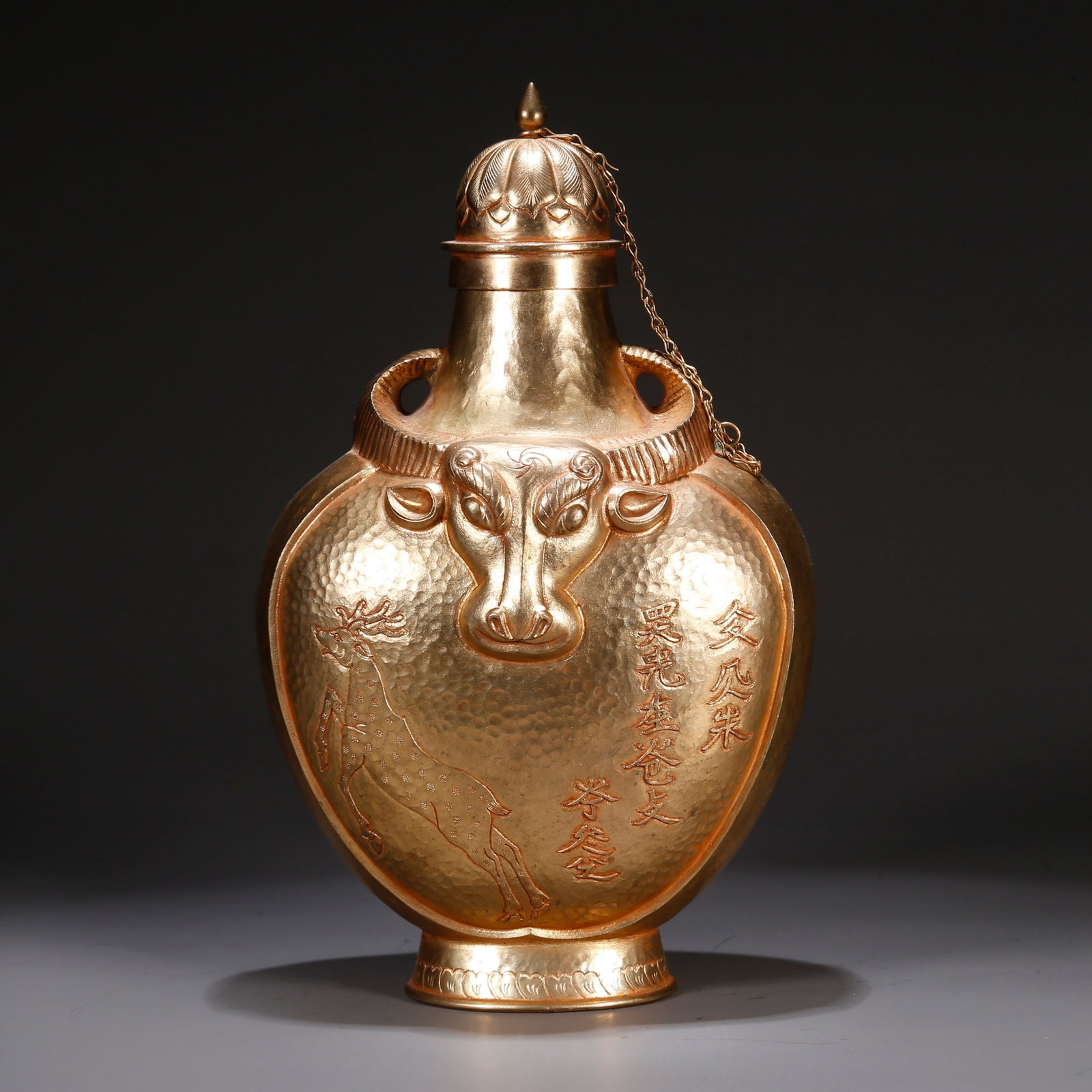 A GILT BRONZE EWER WITH OX-HERDING SCENE: Gilt bronze ewer with ox-herding scene