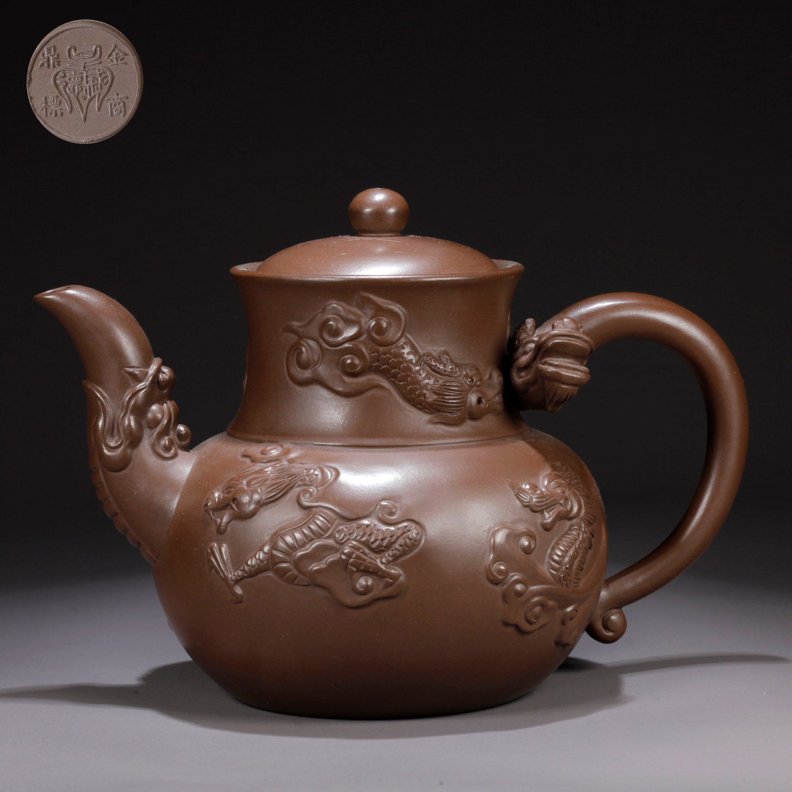 A PURPLE CLAY (ZISHA) TEAPOT WITH CLOUD-AND-DRAGON MOTIF: Purple Clay (Zisha) Teapot with Cloud-and-Dragon Motif