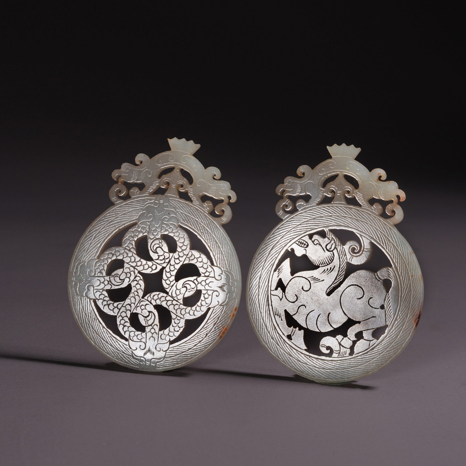 A SET OF HETIAN JADE BI DISCS WITH BEAST MOTIFS (1 of 11)