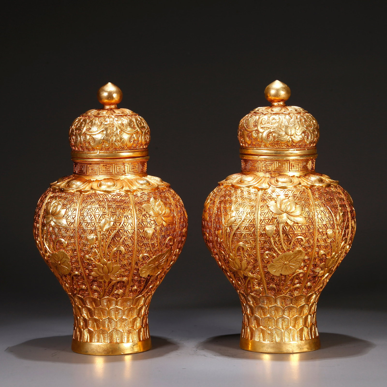 A GILT BRONZE LIDDED BOTTLES WITH FLORAL DESIGN (PAIR): Gilt bronze lidded bottles with floral design (pair)