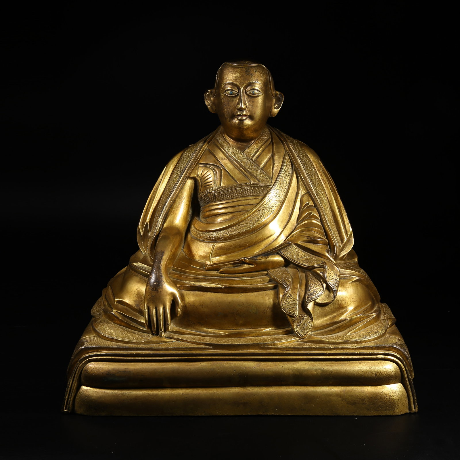 A GILT-BRONZE STATUE OF A LAMA: Gilt-Bronze Statue of a Lama