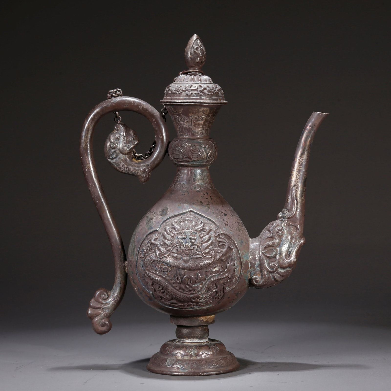 A SILVER EWER WITH CLOUD AND DRAGON MOTIF: Silver ewer with cloud and dragon motif