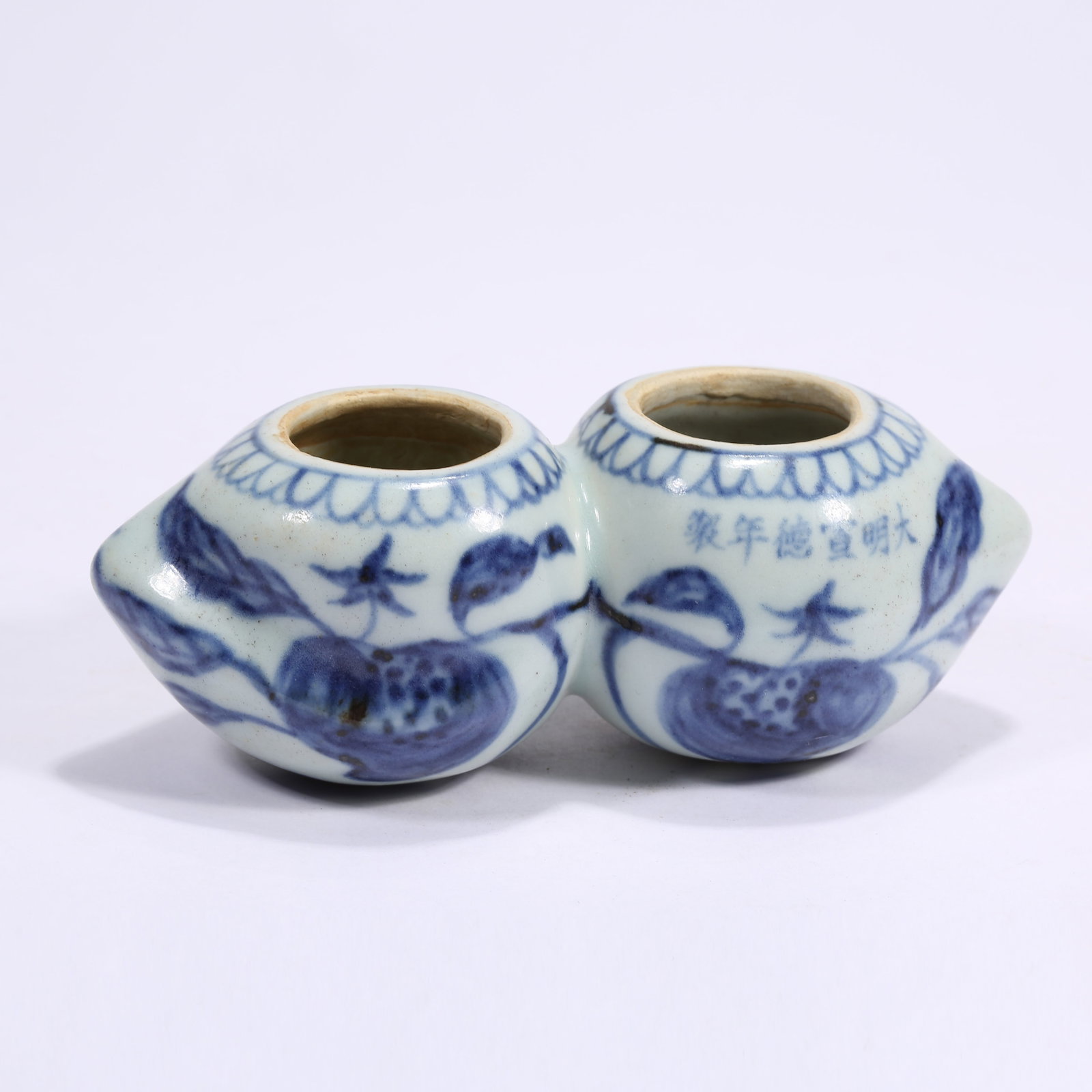 A BLUE-AND-WHITE BIRD-FEEDER JAR IN THE SHAPE OF A LONGEVITY PEACH (1 of 10)