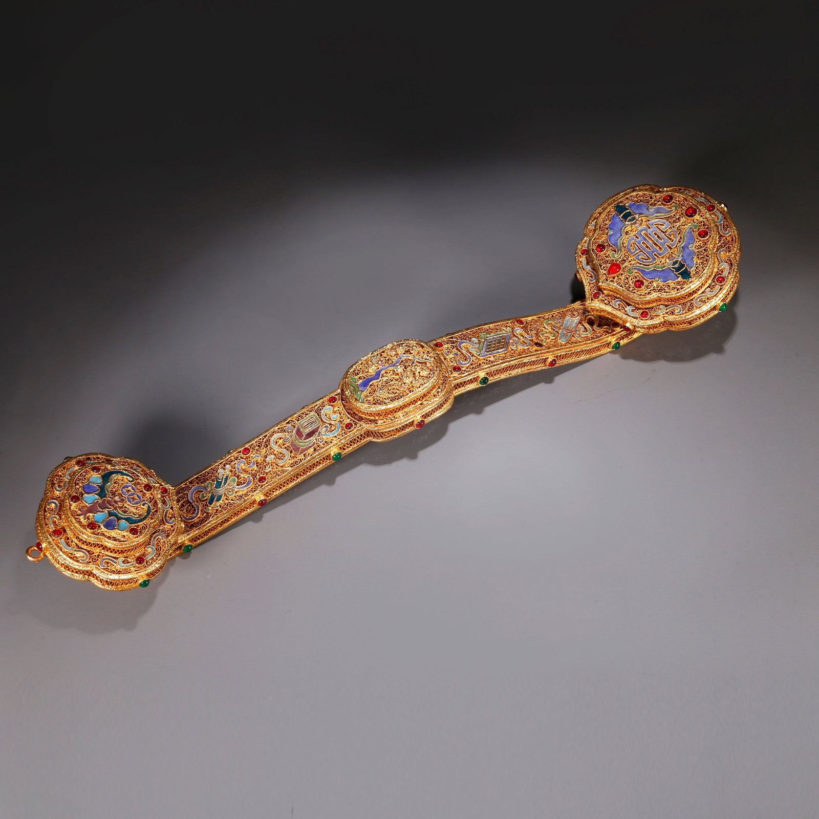 A GILT BRONZE RUYI SCEPTER WITH BLESSING AND LONGEVITY MOTIFS (1 of 11)