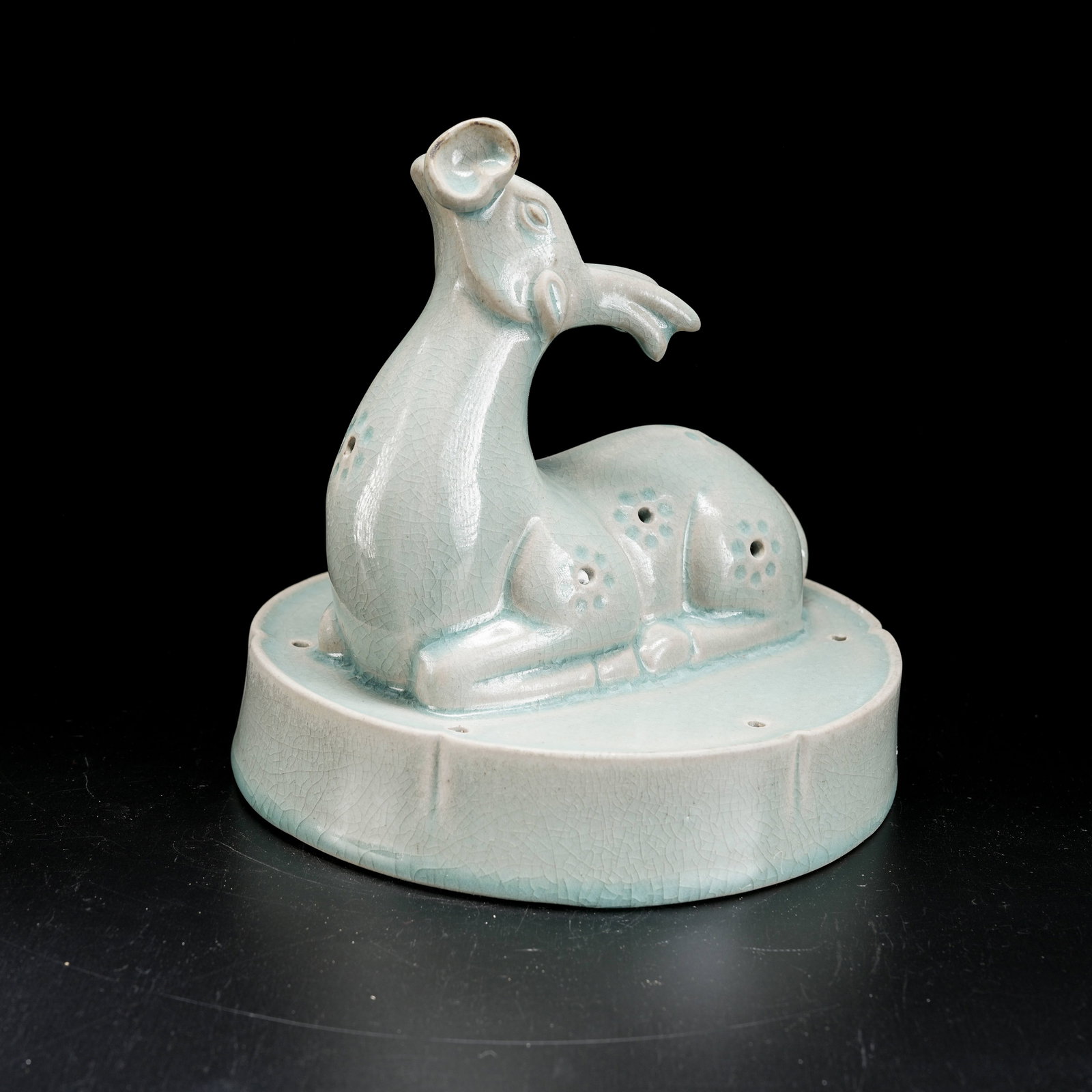A RU KILN RECLINING DEER HOLDING LINGZHI FIGURINE: Ru Kiln Reclining Deer Holding Lingzhi Figurine