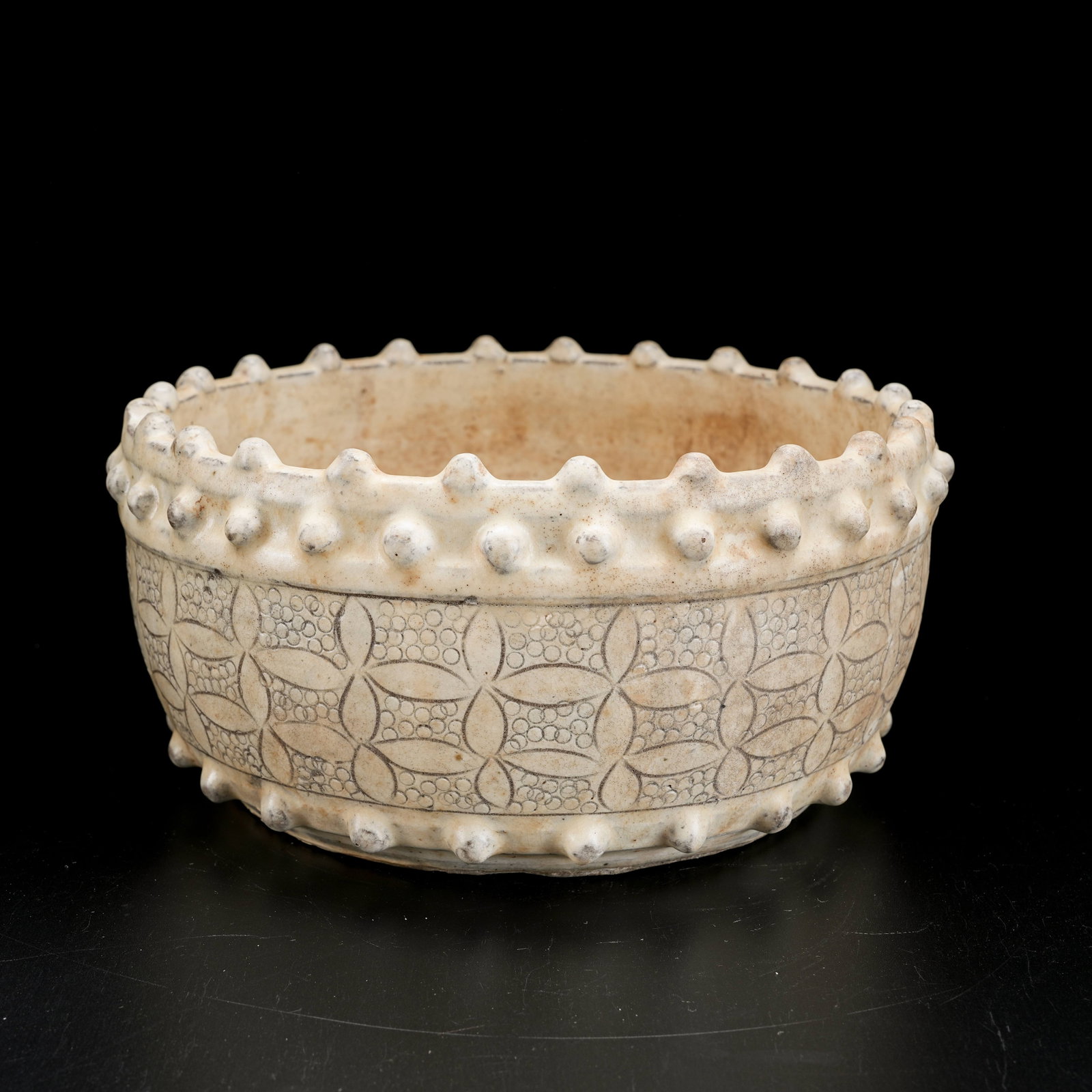A WHITE PORCELAIN WASHER WITH BOSSED FLORAL PATTERN: White Porcelain Washer with Bossed Floral Pattern