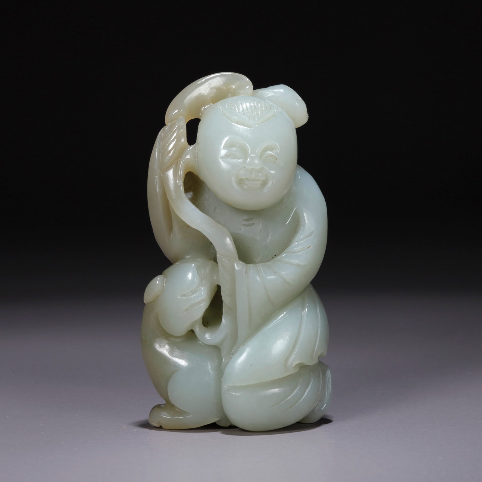 A HETIAN JADE CARVED CHILD-FORM FIGURINE (1 of 9)