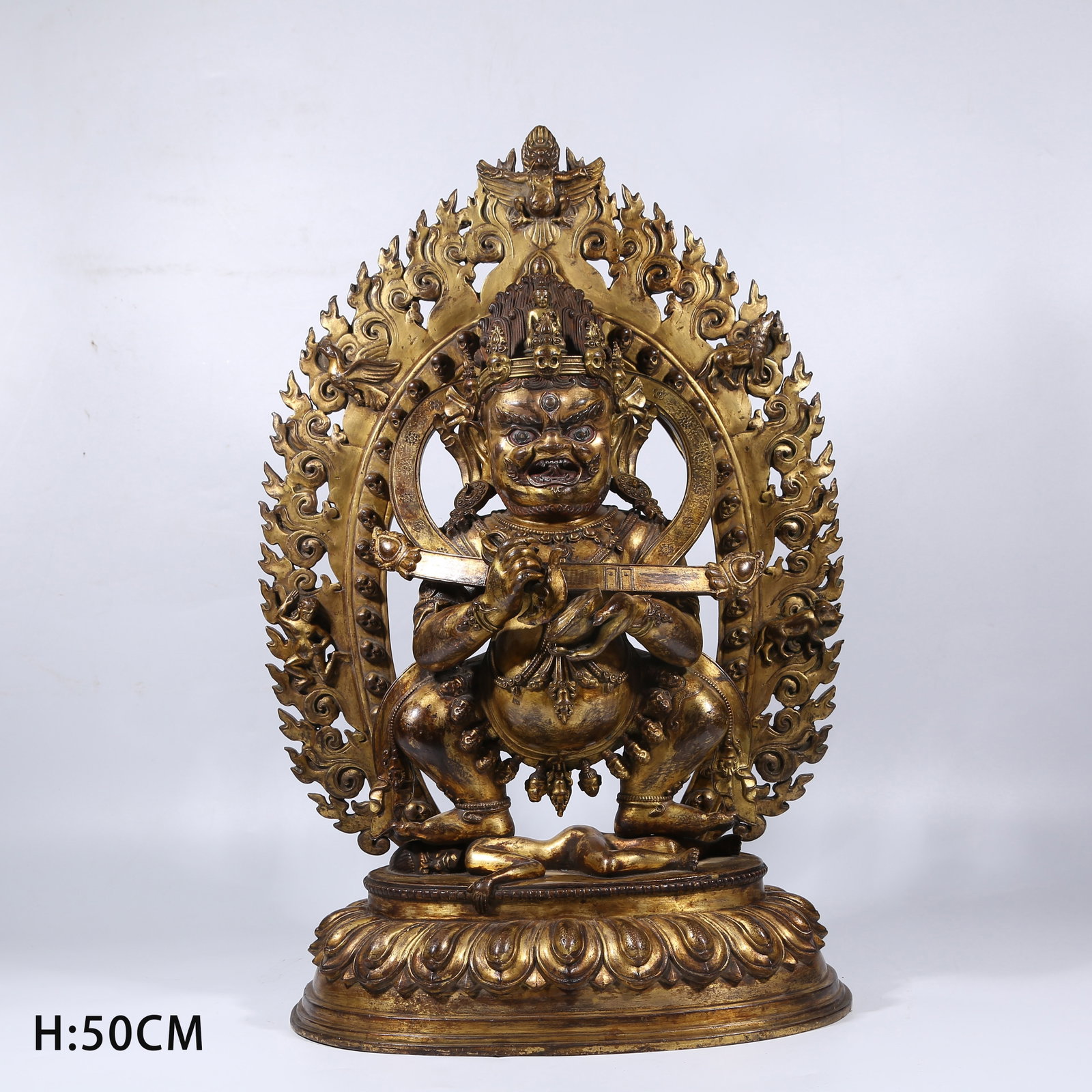 A GILT BRONZE TWO-ARMED MAHAKALA STATUE WITH CLUB (1 of 9)