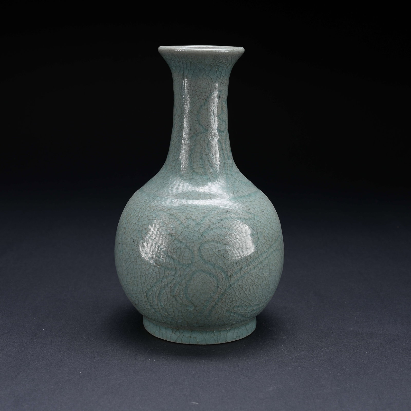 A RU KILN INCISED PHOENIX PATTERN LONG-NECK BOTTLE: Ru Kiln Incised Phoenix Pattern Long-Neck Bottle