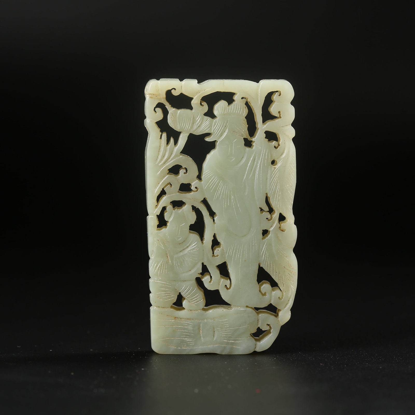 A HETIAN JADE PLAQUE CARVED WITH A CHILD HOLDING A LOTUS: Hetian jade plaque carved with a child holding a lotus