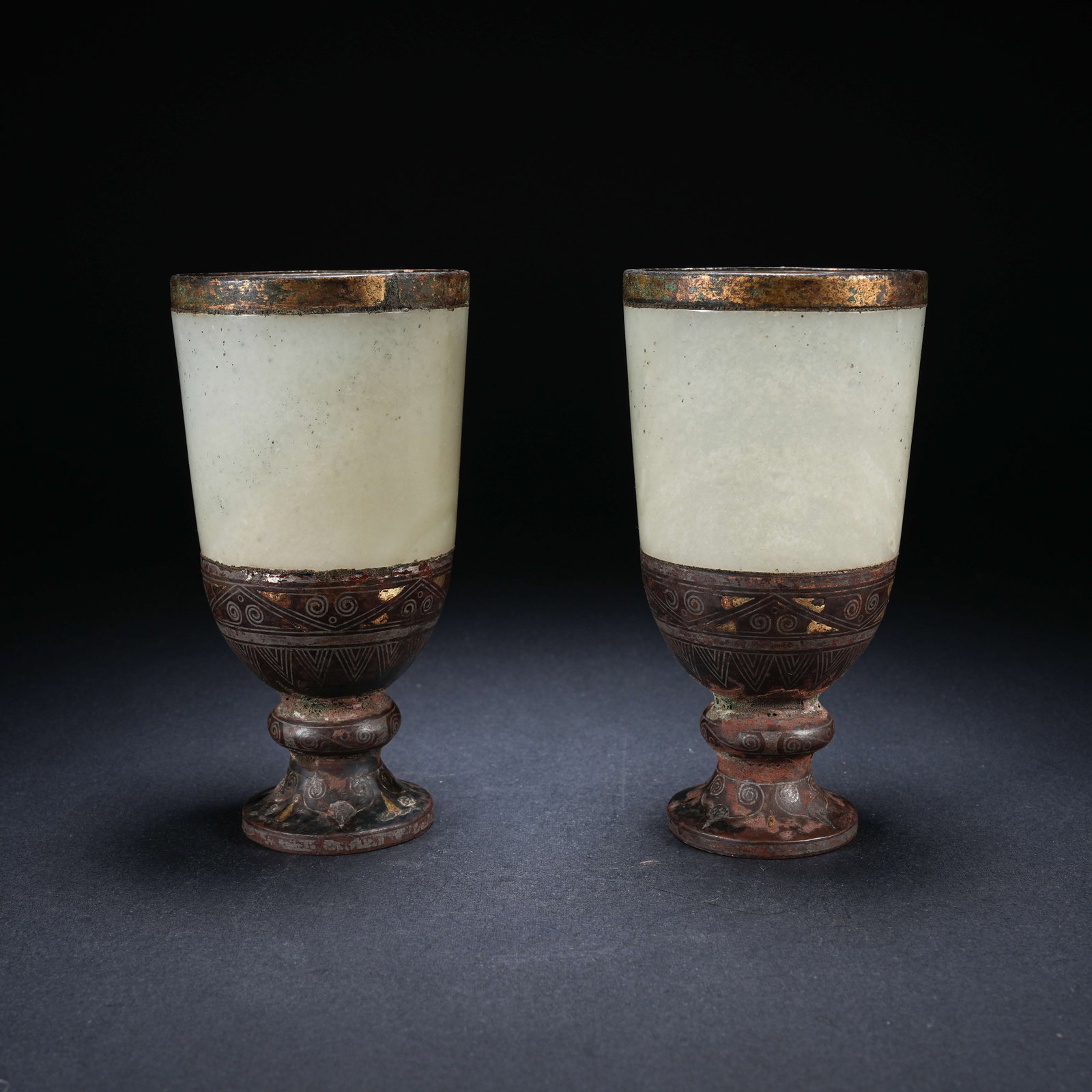 A SET OF ARCHAIC JADE CUPS WITH GOLD AND SILVER INLAY AND BRONZE-MOUNTED RIMS: Set of archaic jade cups with gold and silver inlay and bronze-mounted rims