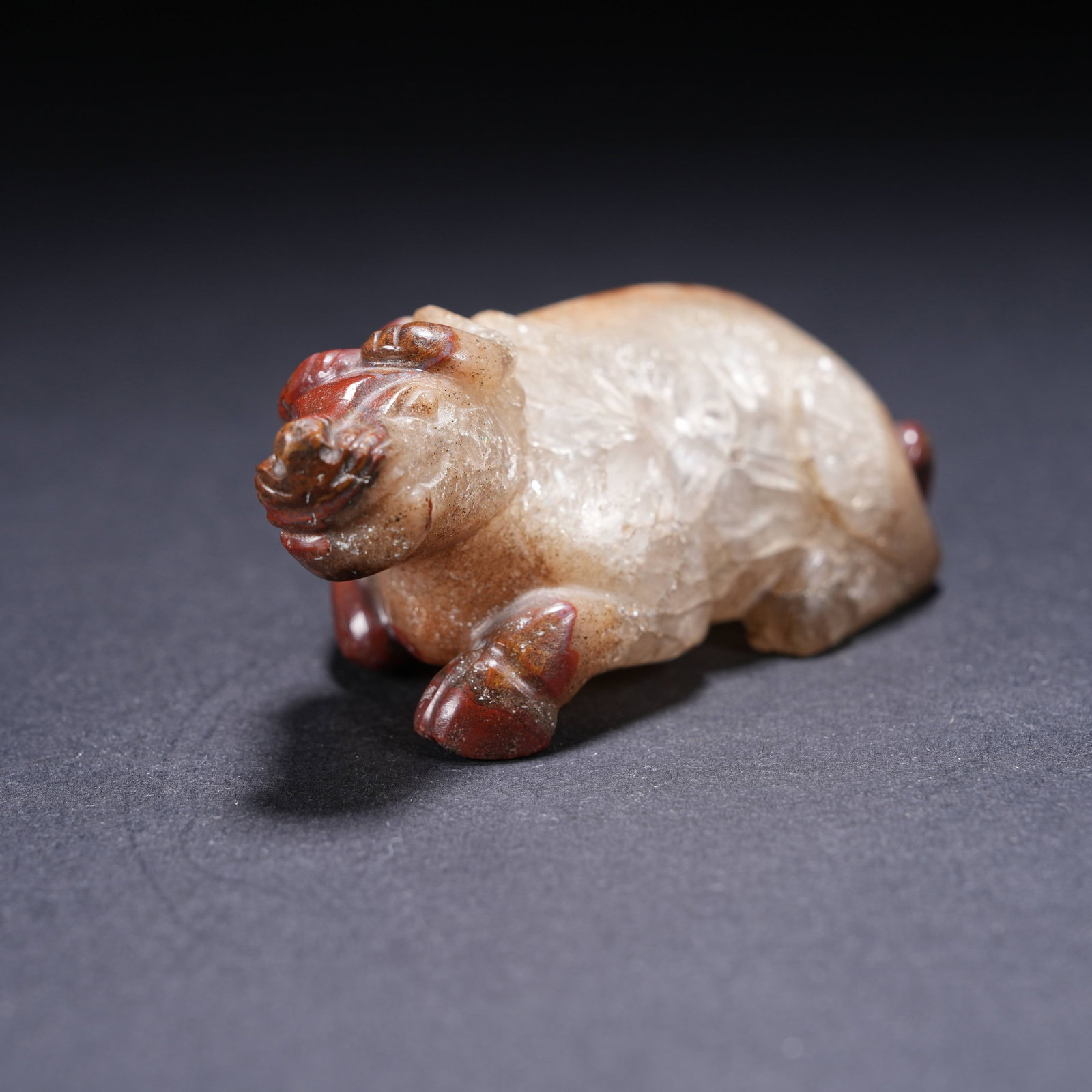 A WARRING STATES RED AGATE RECUMBENT OX FIGURINE (1 of 7)
