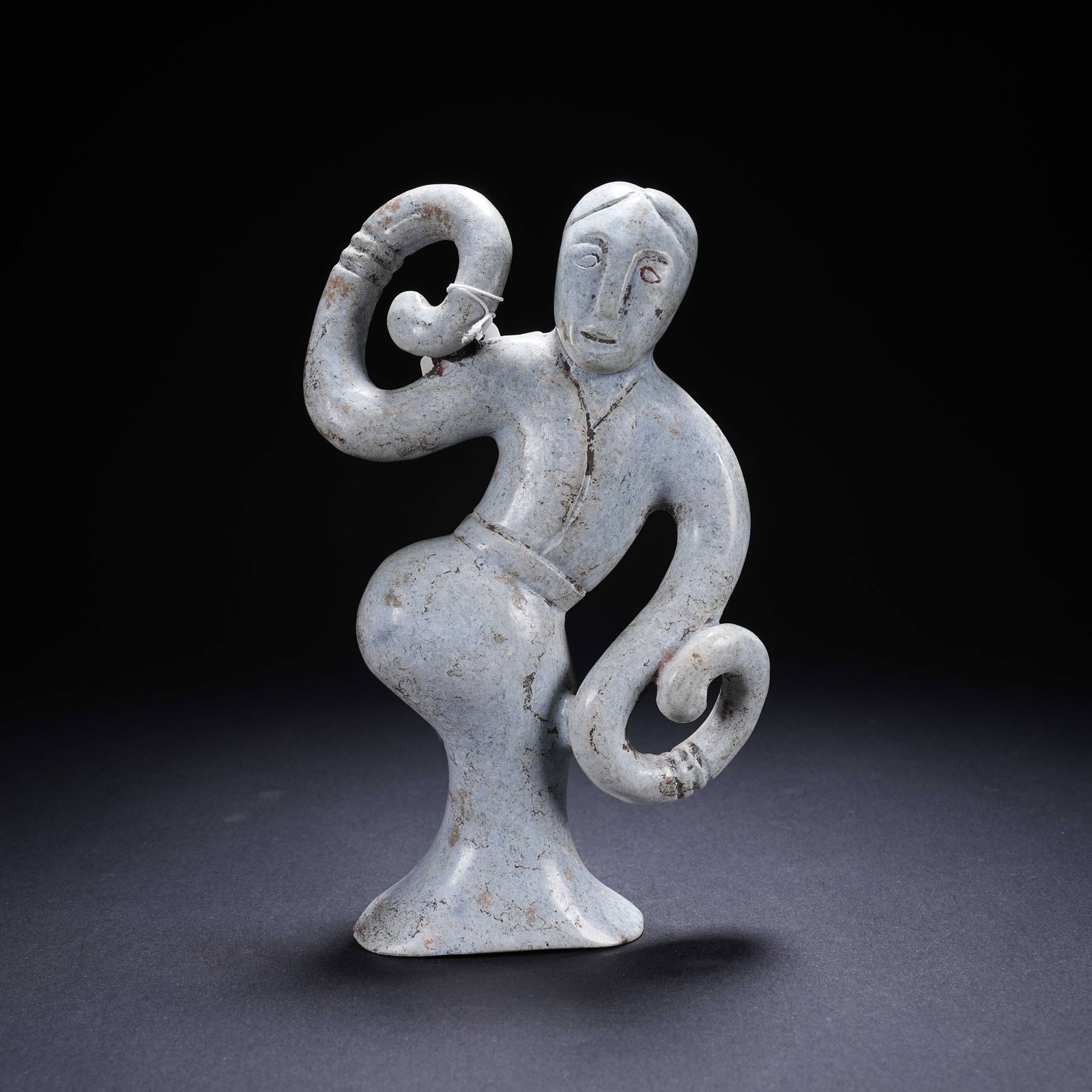 A ARCHAIC JADE DANCING FIGURE (1 of 9)