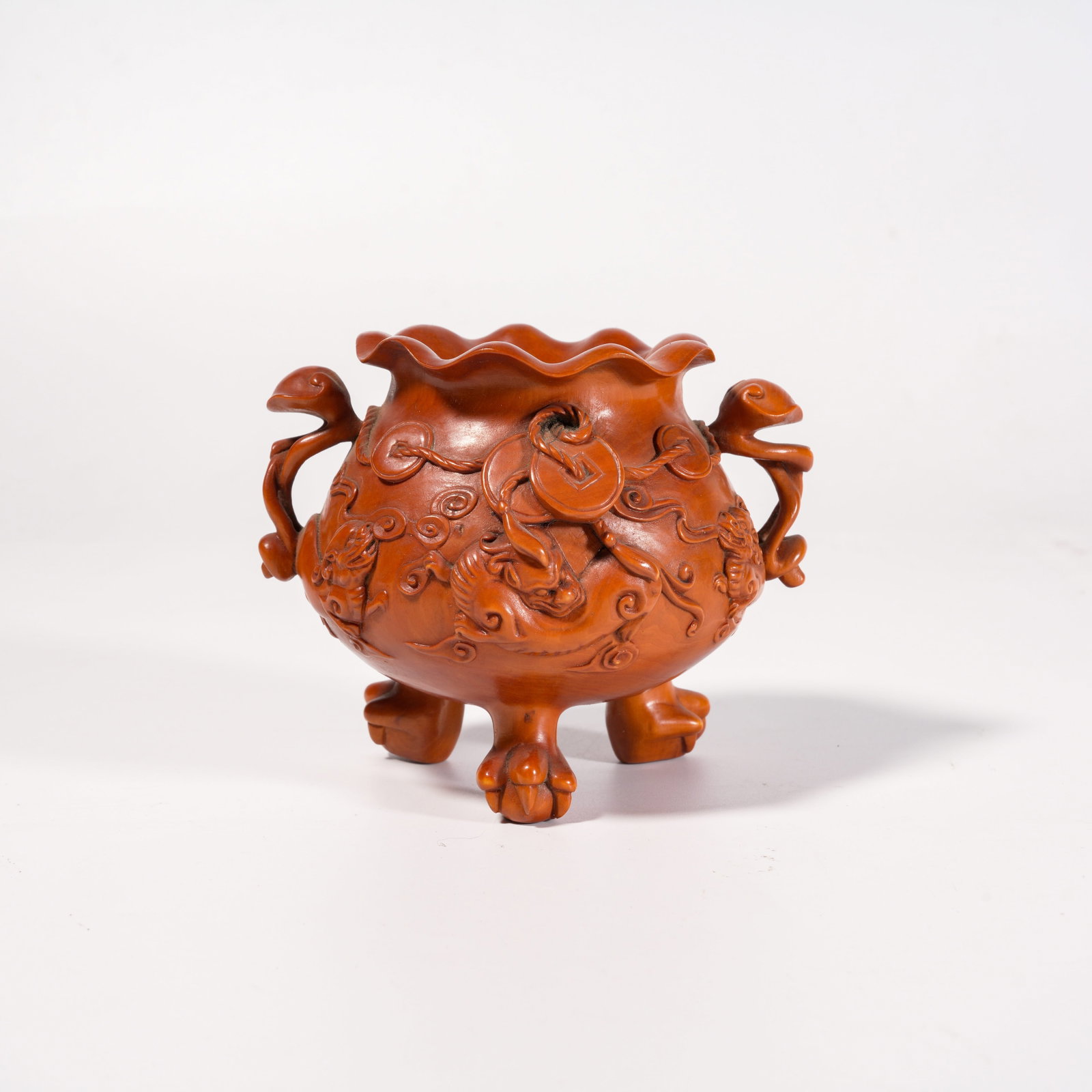A HUANGHUALI WOOD TRIPOD CENSER WITH AUSPICIOUS BEAST MOTIFS AND LINGZHI HANDLES: Huanghuali Wood Tripod Censer with Auspicious Beast Motifs and Lingzhi Handles
