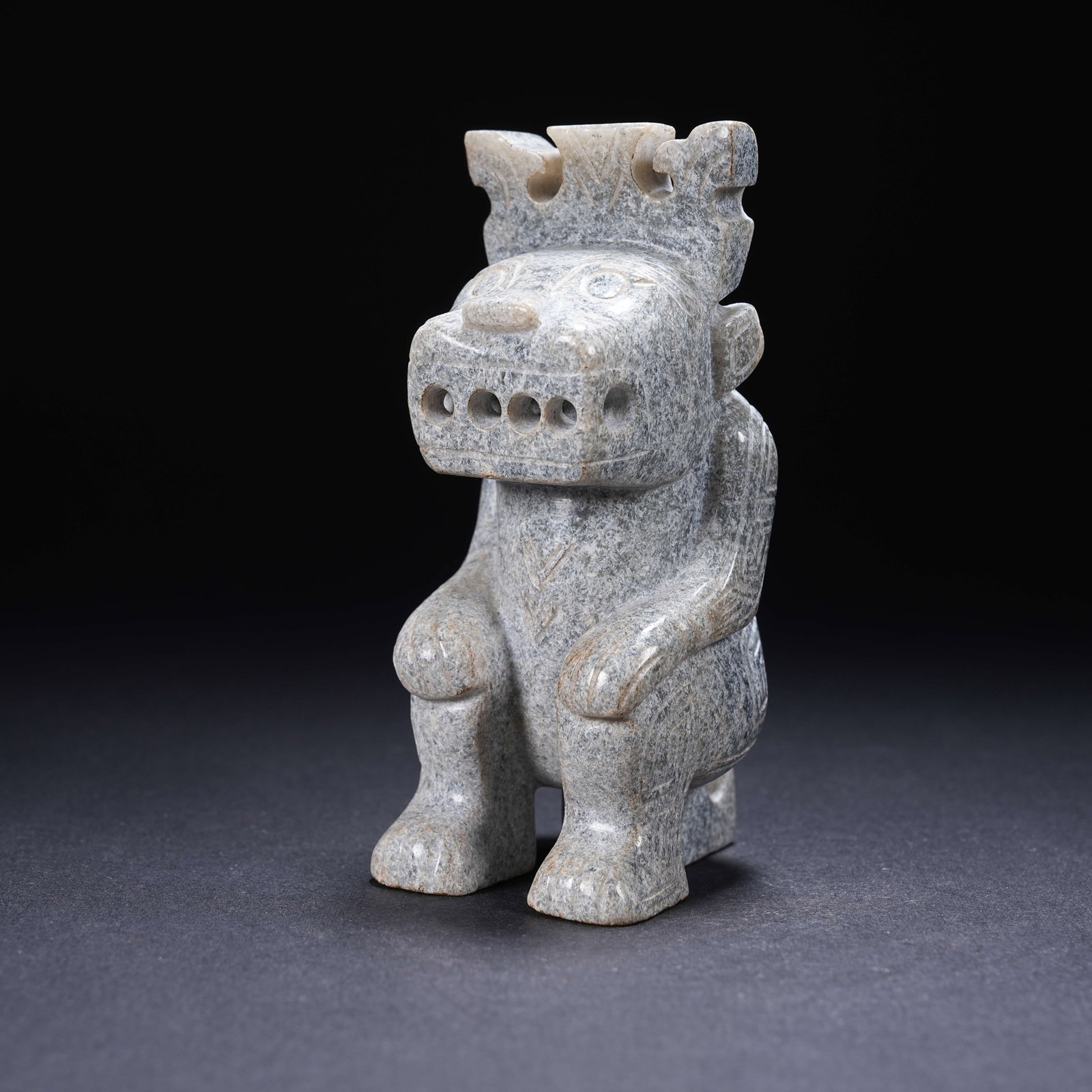 A ARCHAIC JADE KNEELING FIGURE WITH FOUR NOSTRIL OPENINGS: Archaic Jade Kneeling Figure with Four Nostril Openings