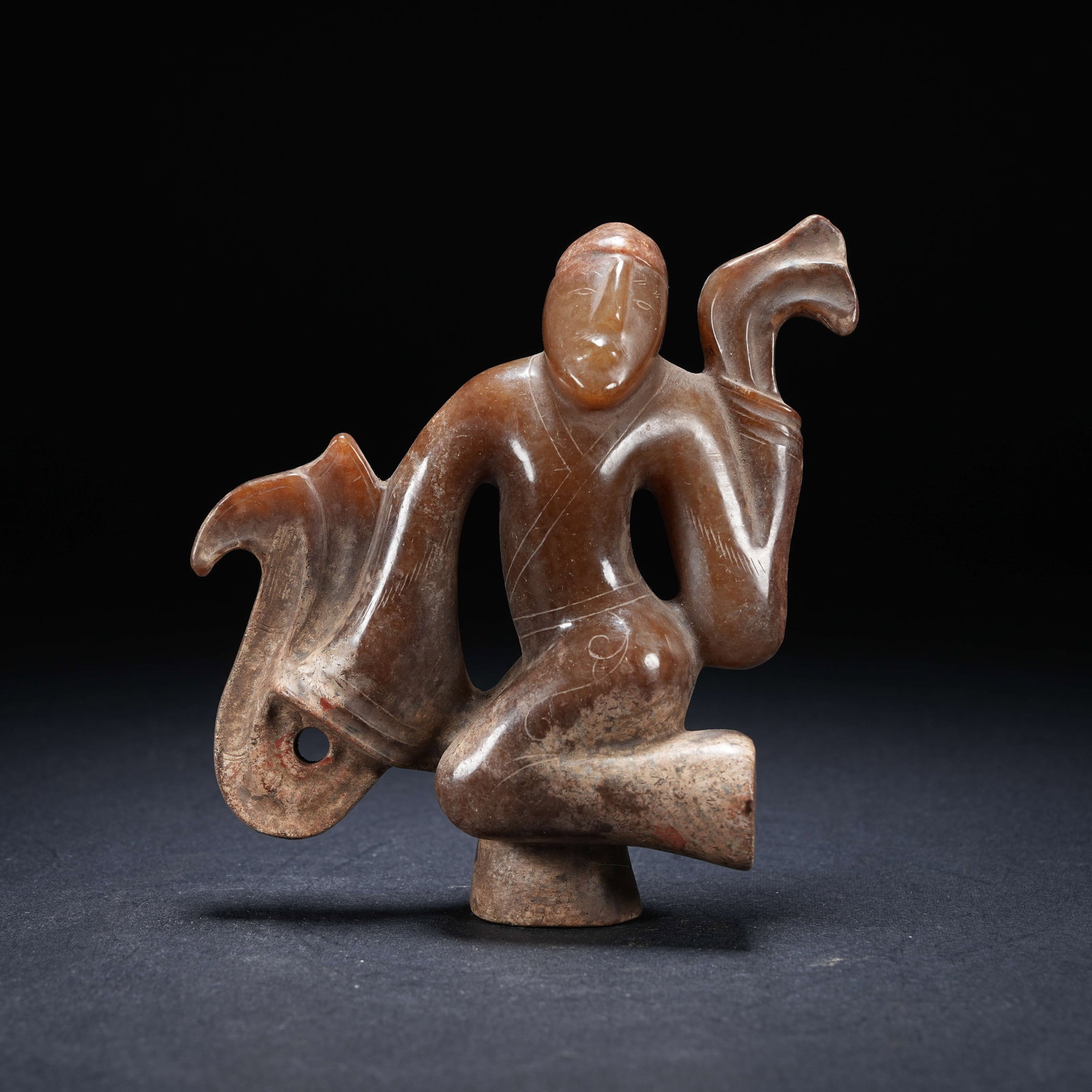 A ARCHAIC JADE DANCING FIGURE (1 of 8)