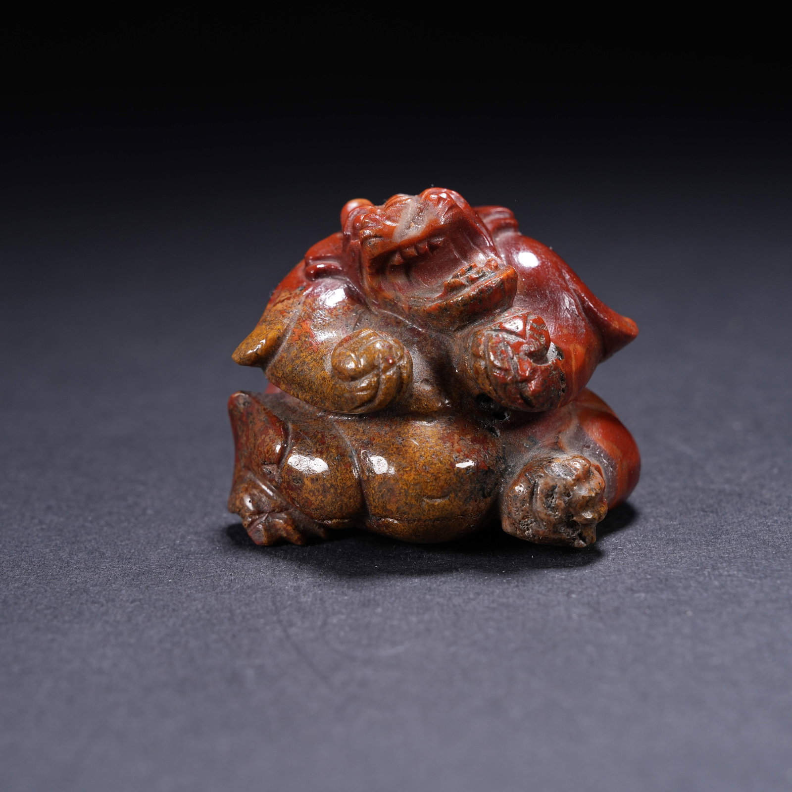 A WARRING STATES RED AGATE SQUATTING BEAR: Warring States Red Agate Squatting Bear