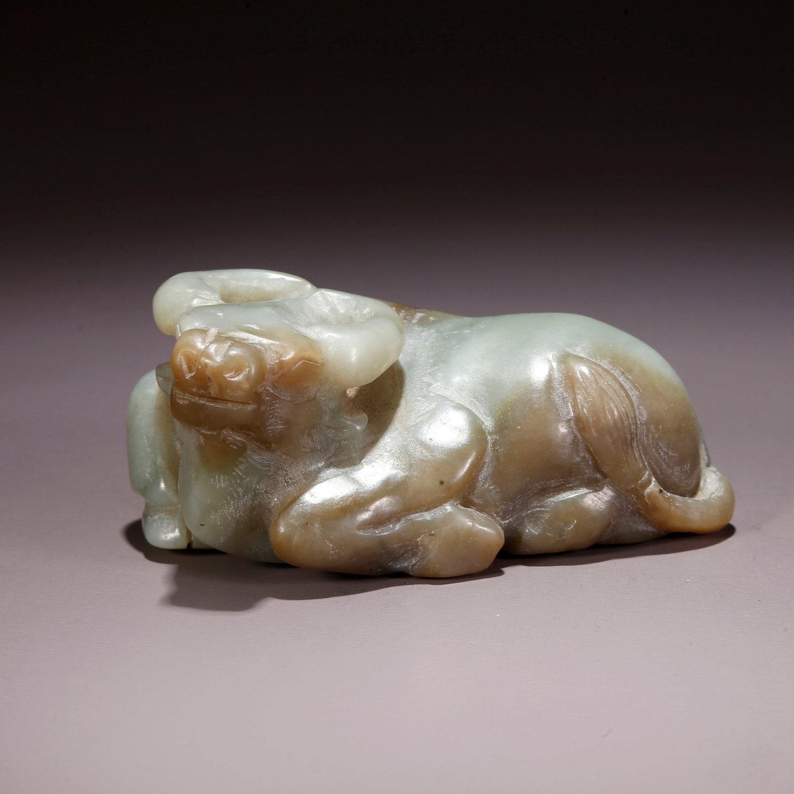 A HETIAN JADE HERDING OX FIGURINE (1 of 10)