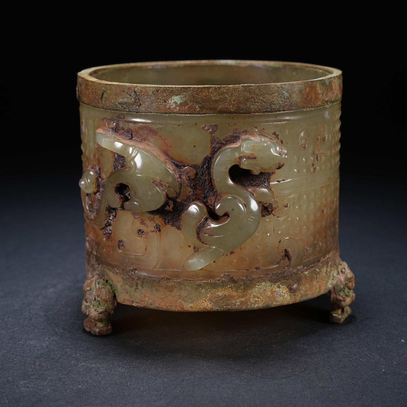 A ARCHAIC JADE TRIPOD CUP WITH CHI DRAGON PATTERNS AND BRONZE-MOUNTED RIM (1 of 9)