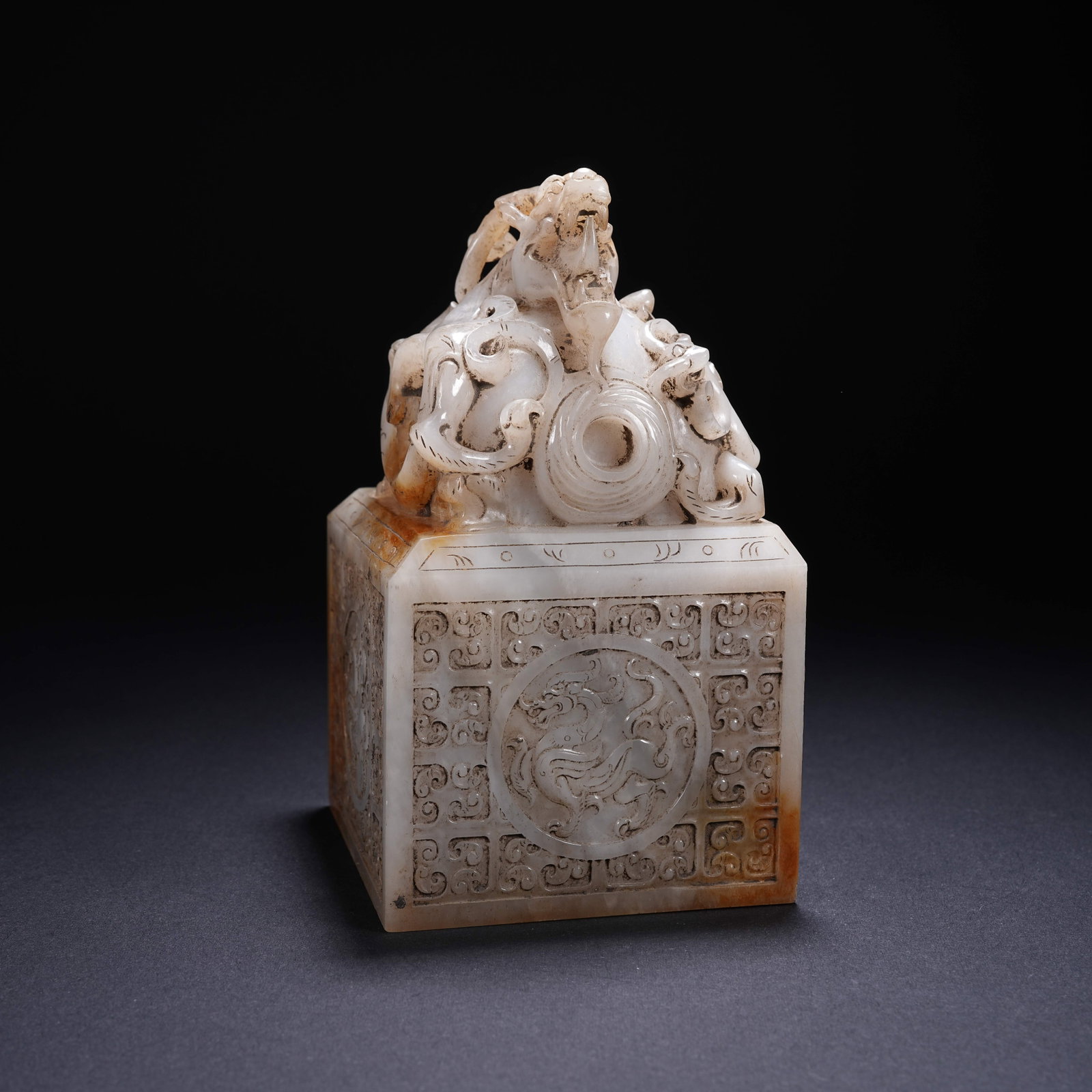 A ARCHAIC JADE SEAL WITH CHILONG KNOB AND "FOUR DEITIES" MOTIF: Archaic Jade Seal with Chilong Knob and "Four Deities" Motif