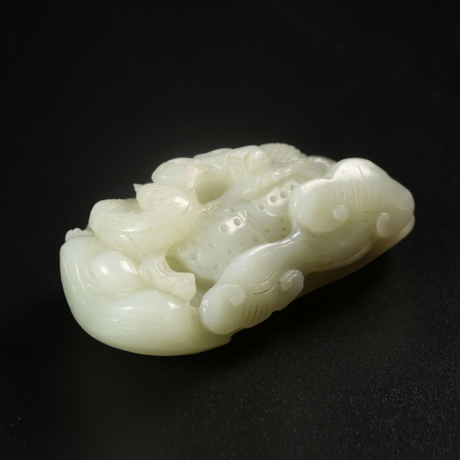 A HETIAN JADE HANDHELD CARVING WITH DRAGON MOTIFS (1 of 7)