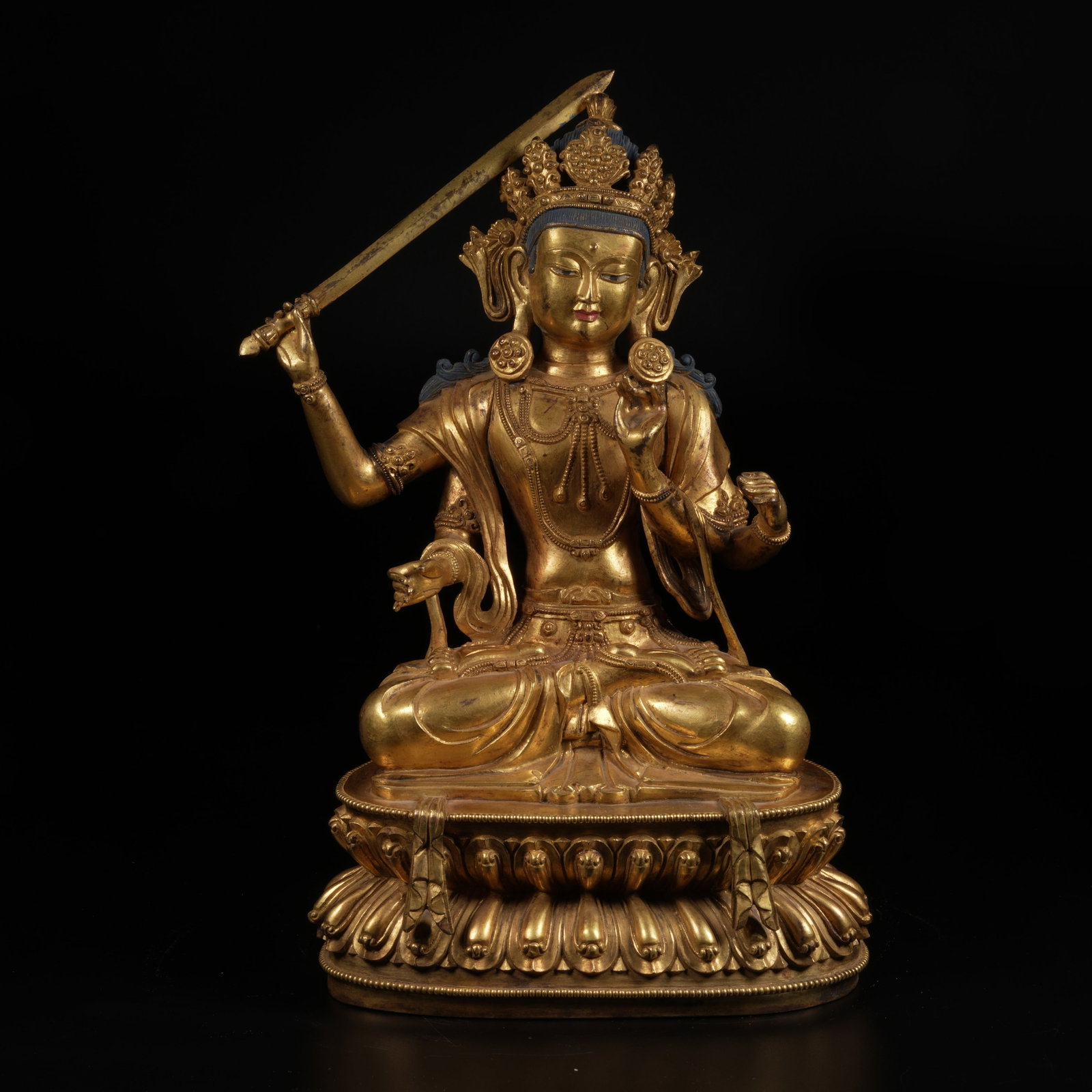 A GILT-BRONZE FOUR-ARMED MANJUSHRI BODHISATTVA STATUE: Gilt-Bronze Four-Armed Manjushri Bodhisattva Statue