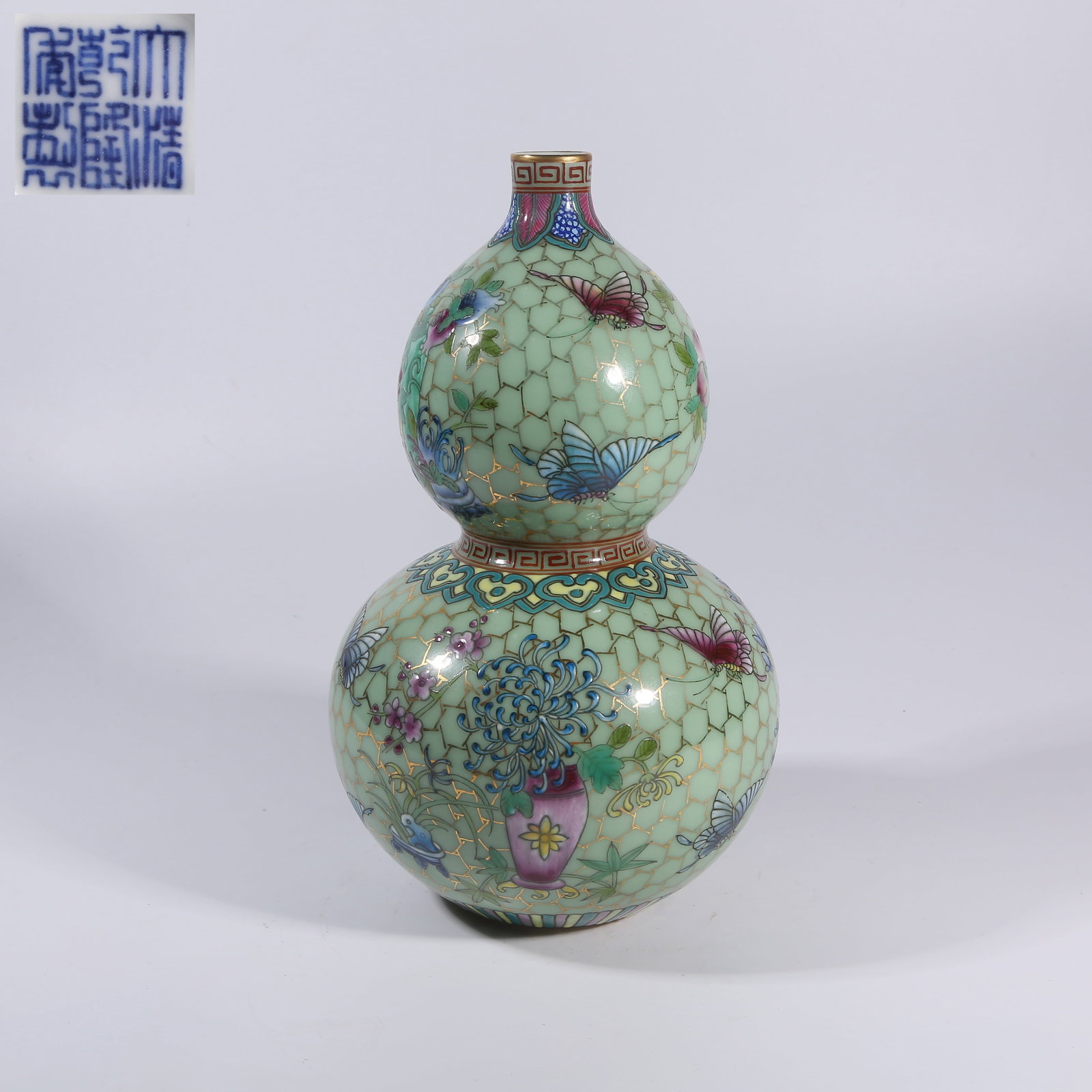 A FAMILLE-ROSE GILT-OUTLINED GOURD-SHAPED VASE WITH BUTTERFLY AND FLORAL MOTIFS: Famille-rose Gilt-Outlined Gourd-shaped Vase with Butterfly and Floral Motifs