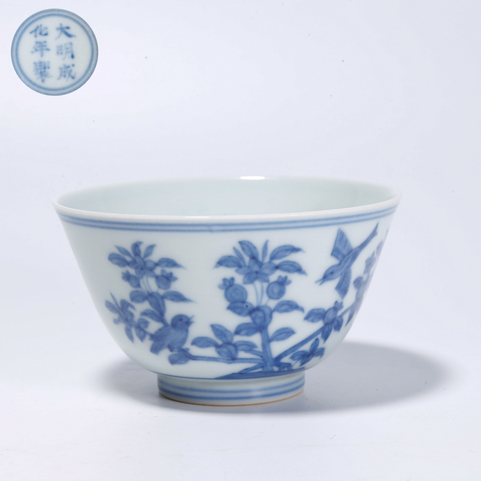 A BLUE-AND-WHITE CUP WITH FLOWER AND BIRD PATTERN: Blue-and-White Cup with Flower and Bird Pattern