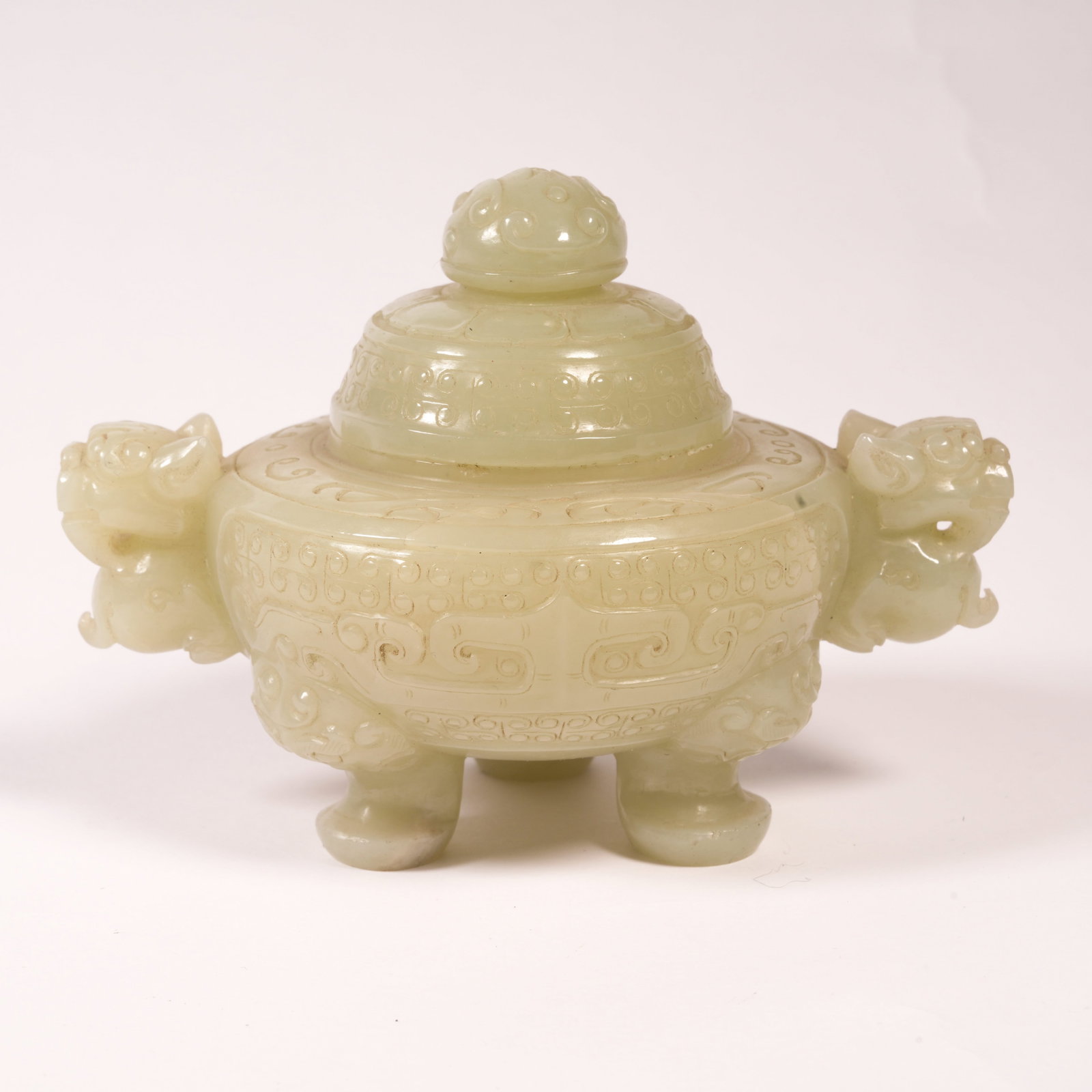 A HETIAN JADE TRIPOD CENSER WITH BEAST-MASK DECORATION AND LOOP HANDLES (1 of 9)