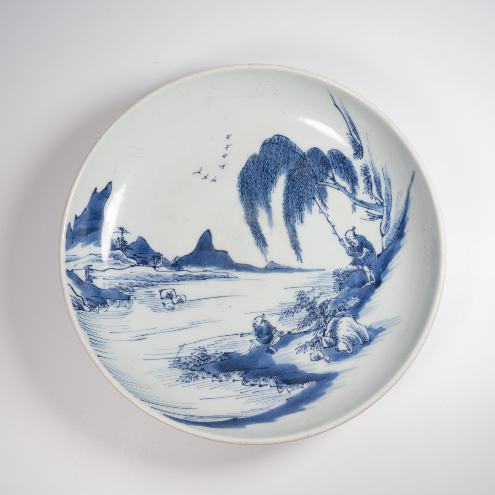 A BLUE-AND-WHITE LARGE DISH WITH "FISHERMEN AT PLAY" SCENE: Blue-and-White Large Dish with "Fishermen at Play" Scene