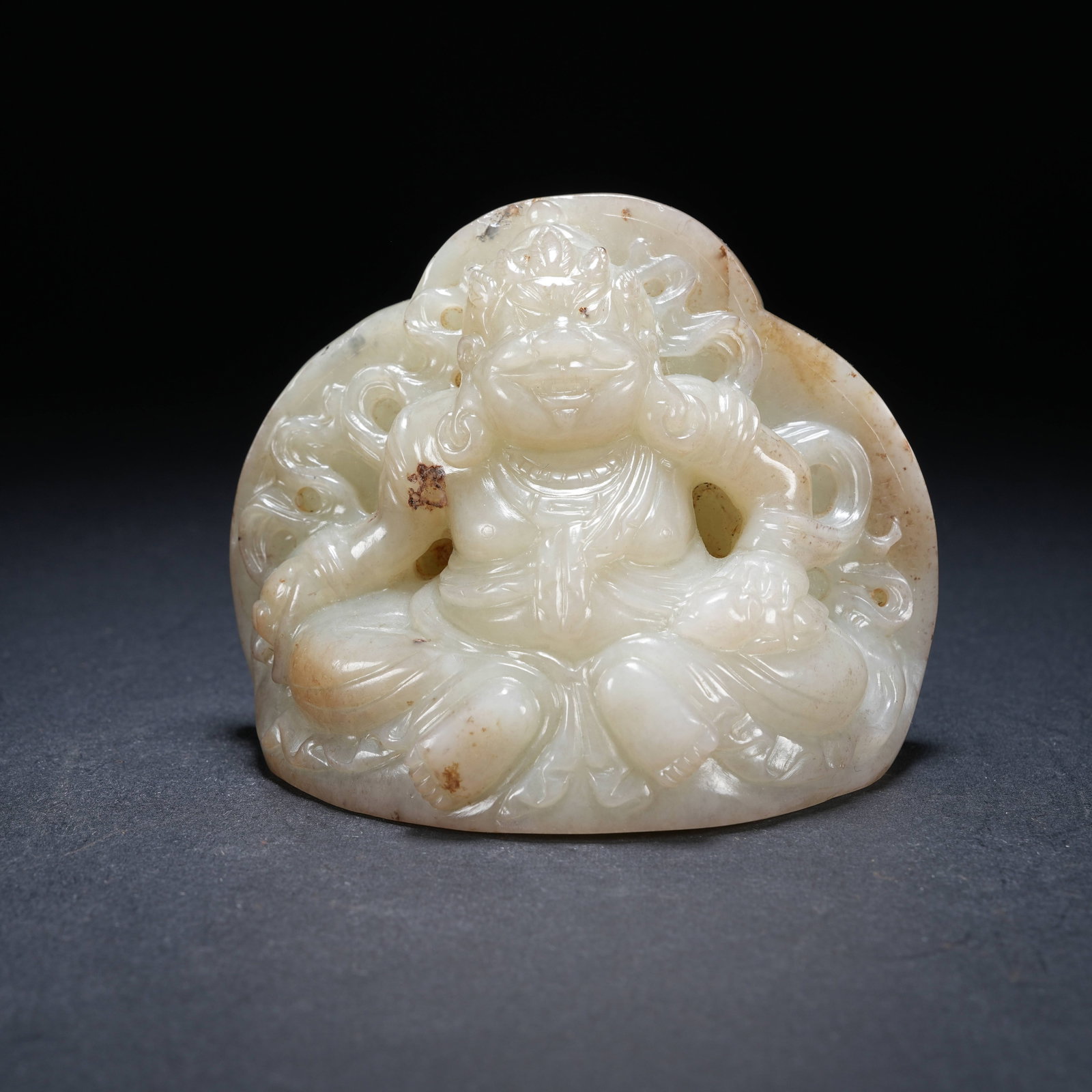 A HOTAN JADE STATUE OF YELLOW JAMBHALA: Hotan Jade Statue of Yellow Jambhala