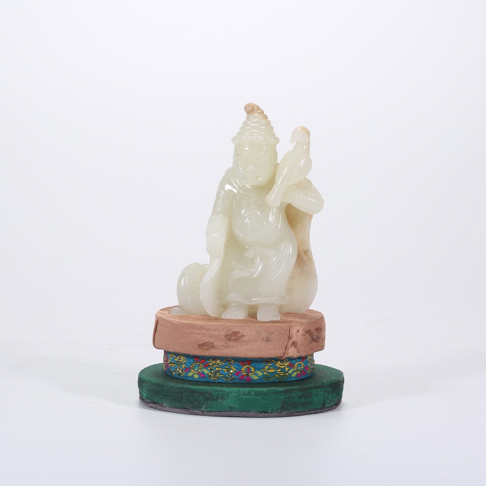 A HETIAN WHITE JADE FIGURINE OF A HU PERSON: Hetian White Jade Figurine of a Hu Person